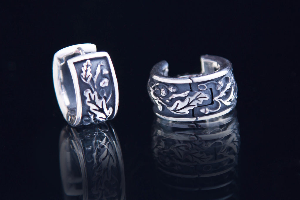 Detailed oak leaf and acorn texture on silver earrings