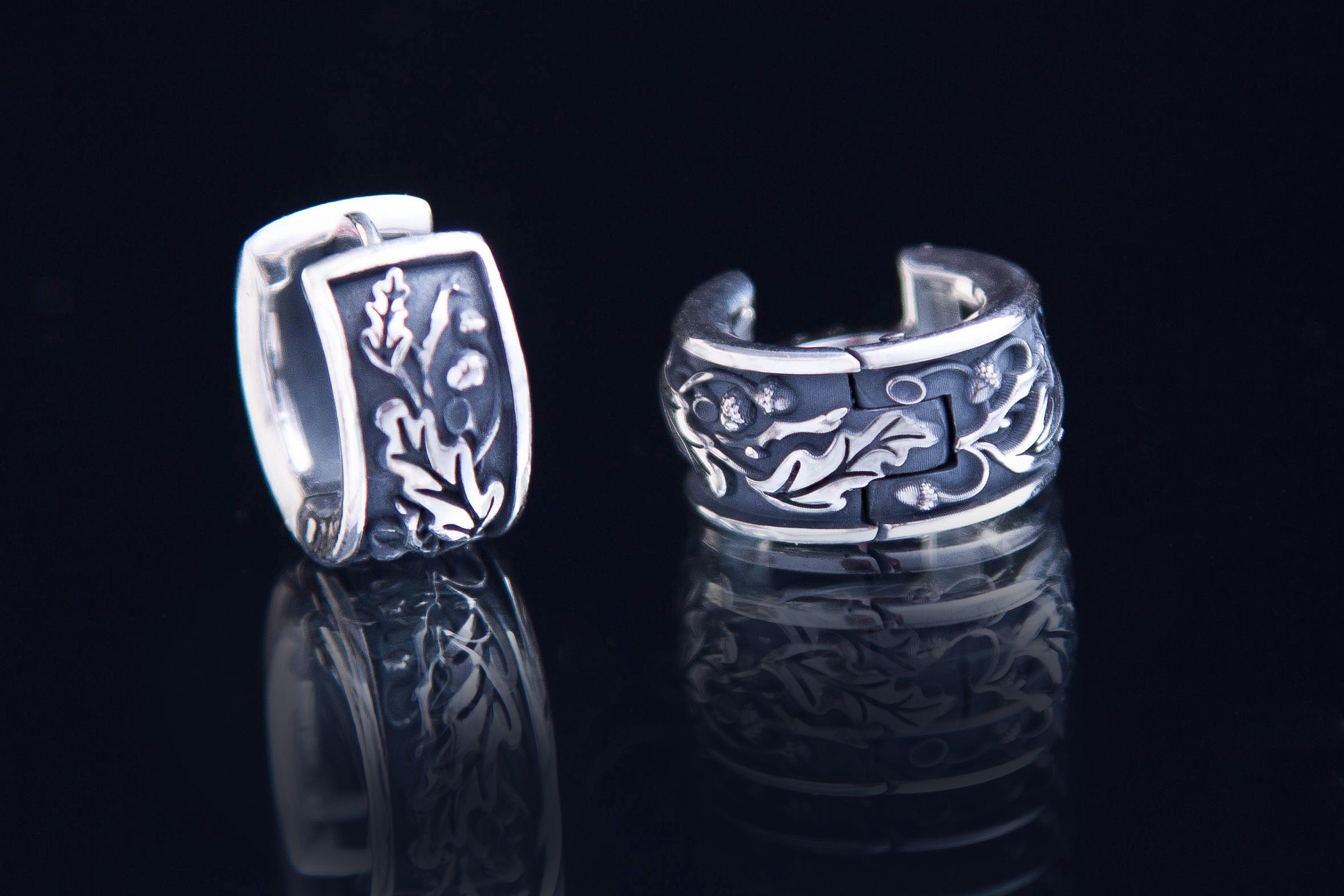 Detailed oak leaf and acorn texture on silver earrings