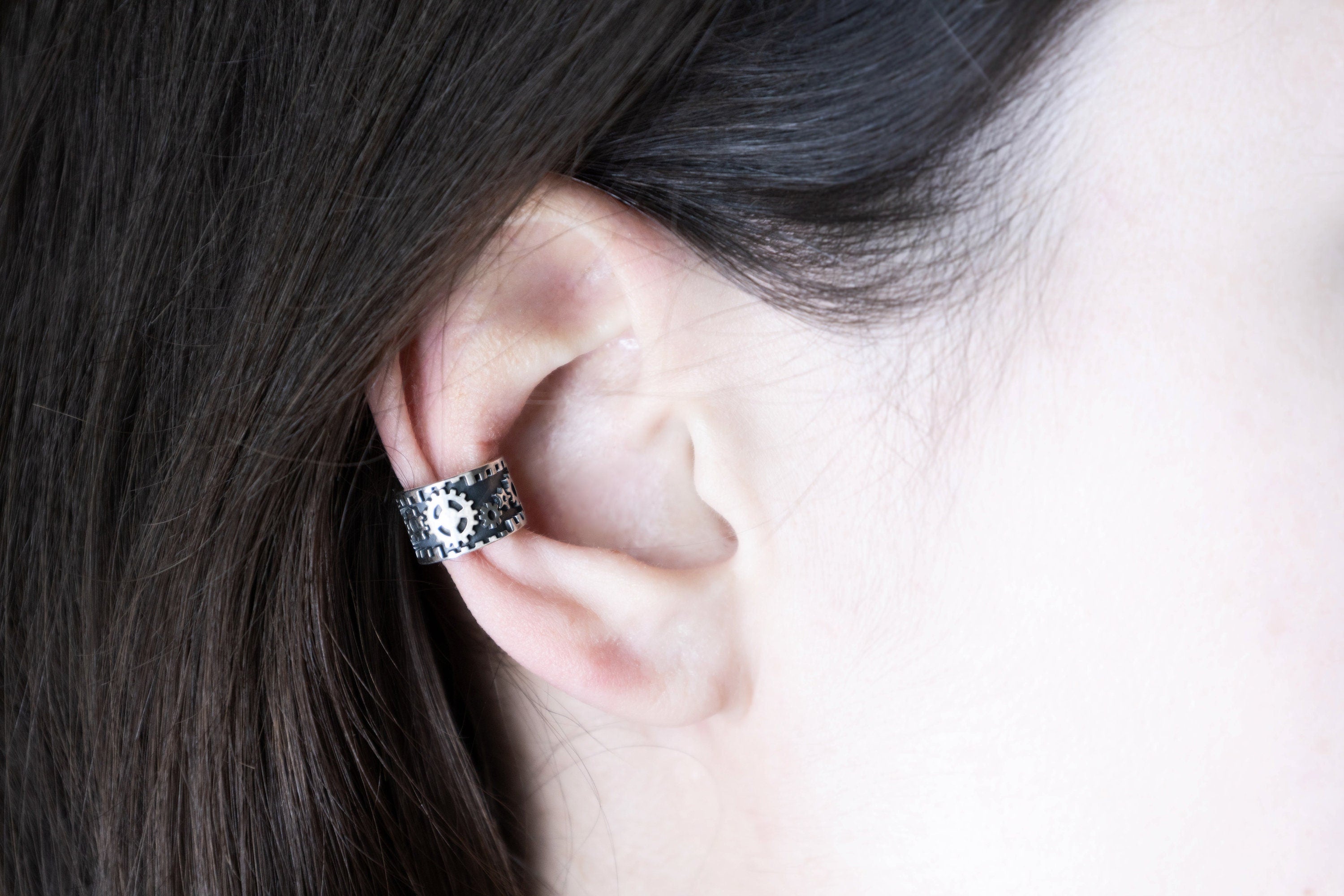 Industrial style silver ear cuff worn on cartilage