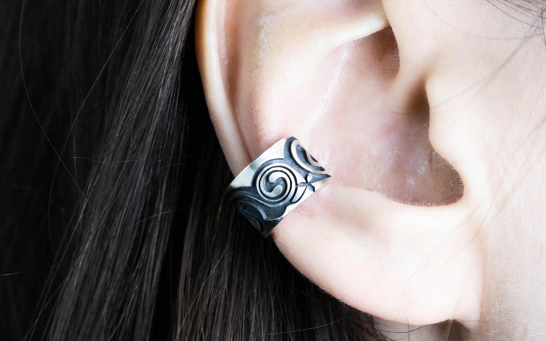 Celtic silver ear cuff worn on ear, no piercing design