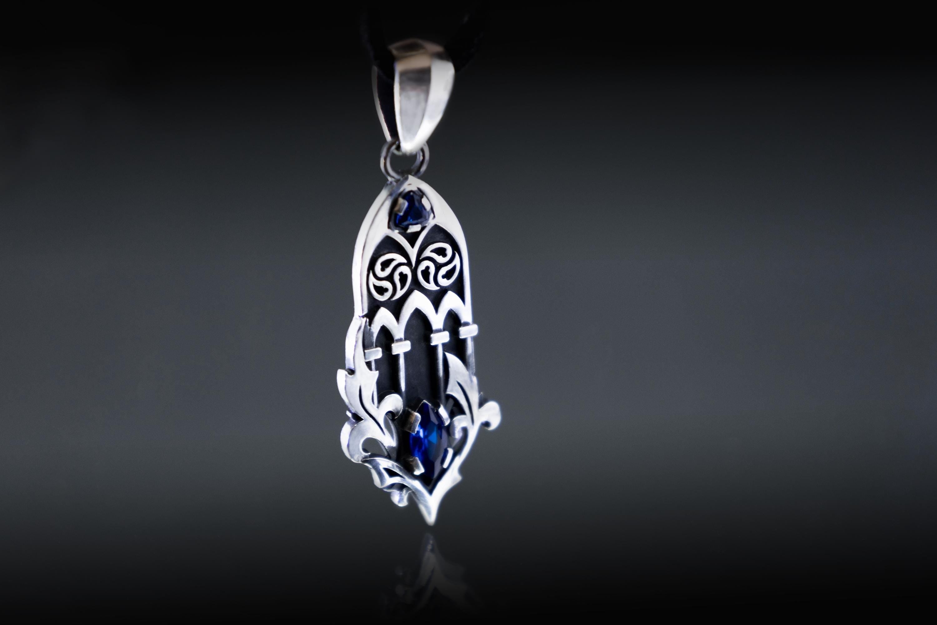 Architectural silver pendant with blue zircon gemstone