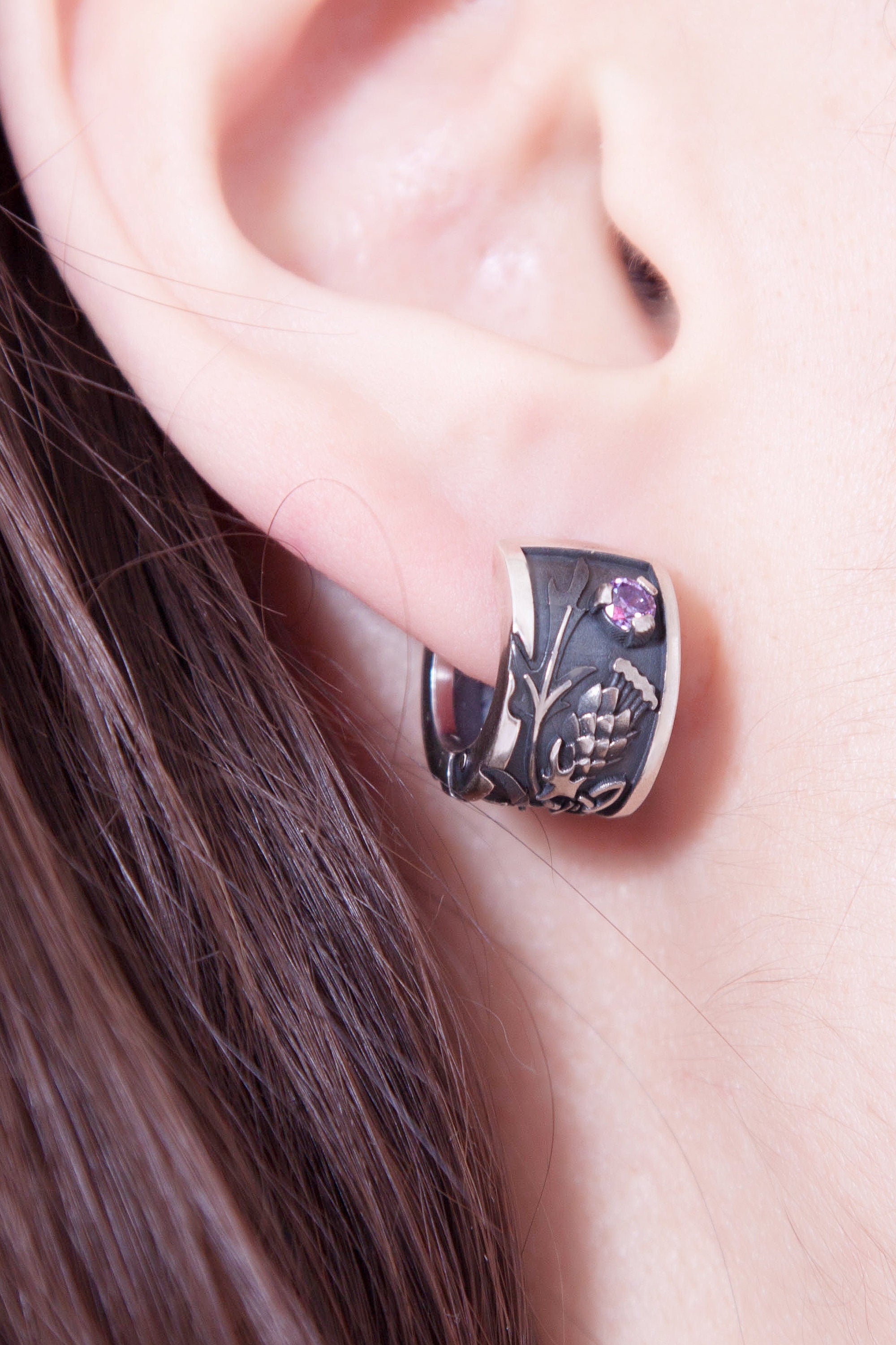Thistle flower silver hoop earring worn on ear