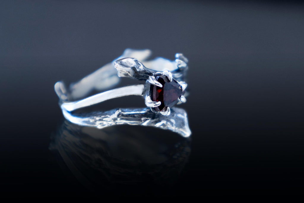 Side view of sterling silver branch ring with garnet stone