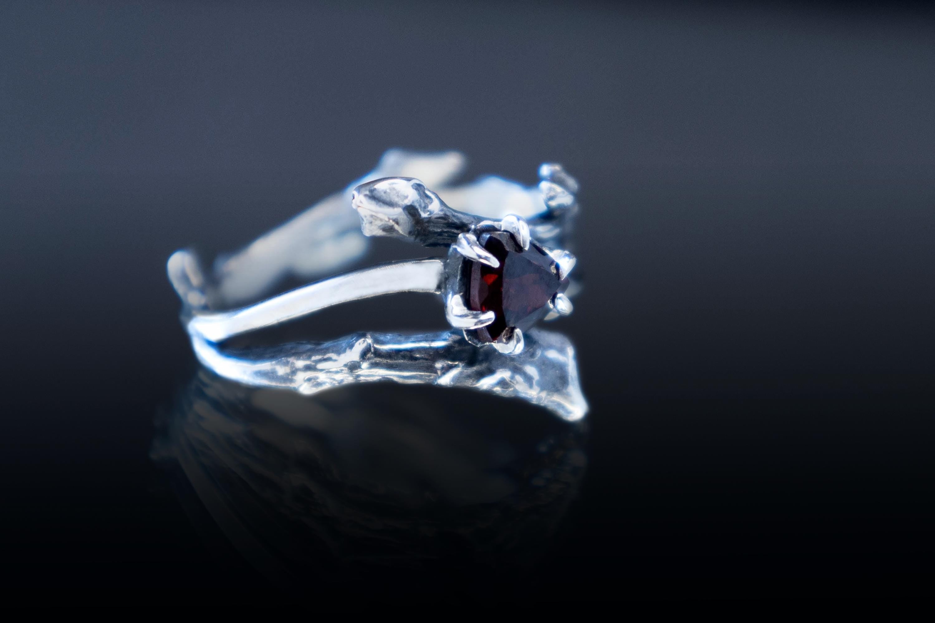 Side view of sterling silver branch ring with garnet stone
