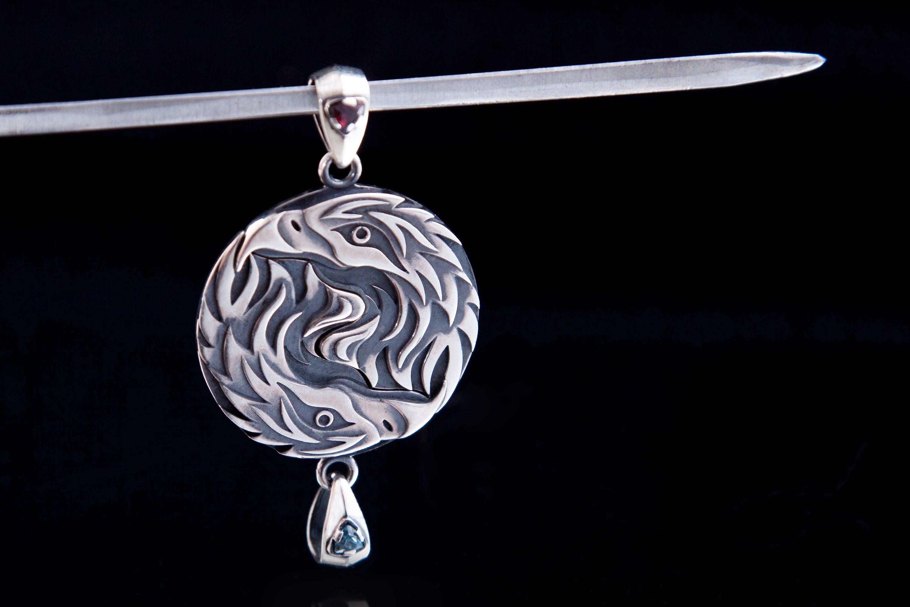 Minimalist silver eagle pendant worn as a symbolic pair necklace