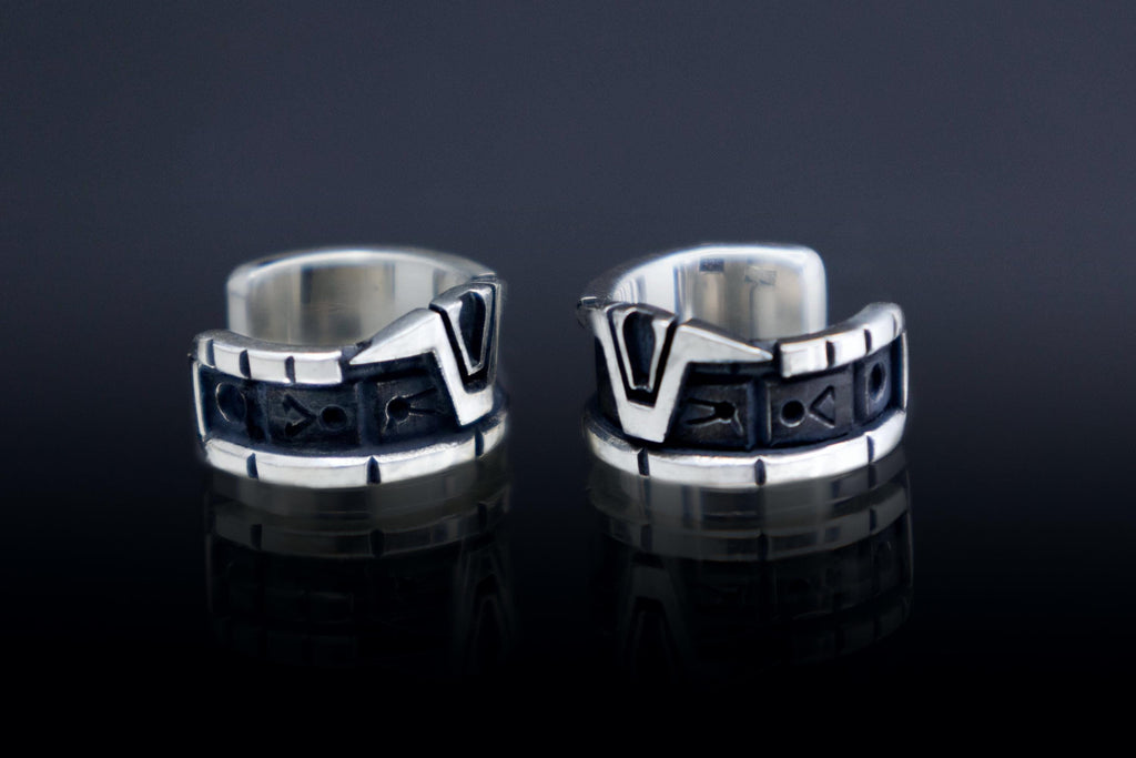 Close-up of sci-fi silver ear cuff with glyphs