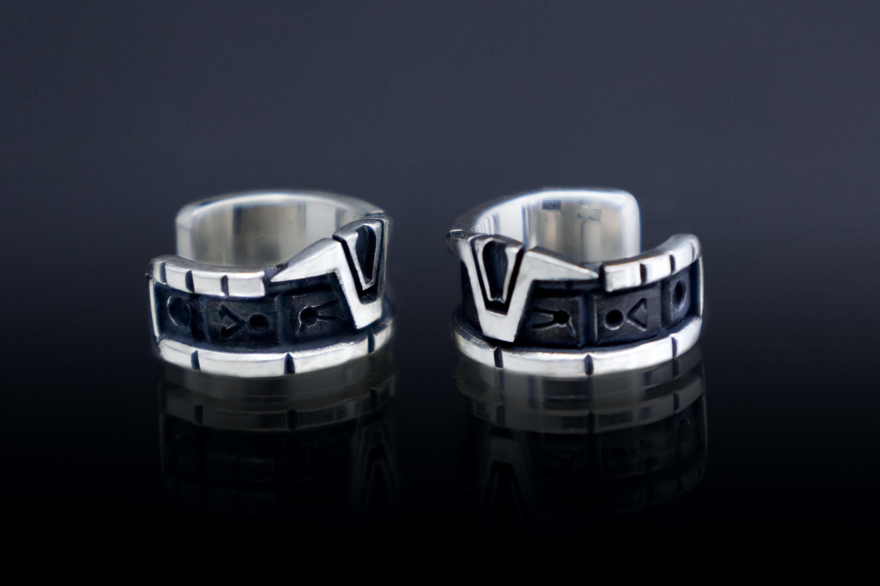 Close-up of sci-fi silver ear cuff with glyphs