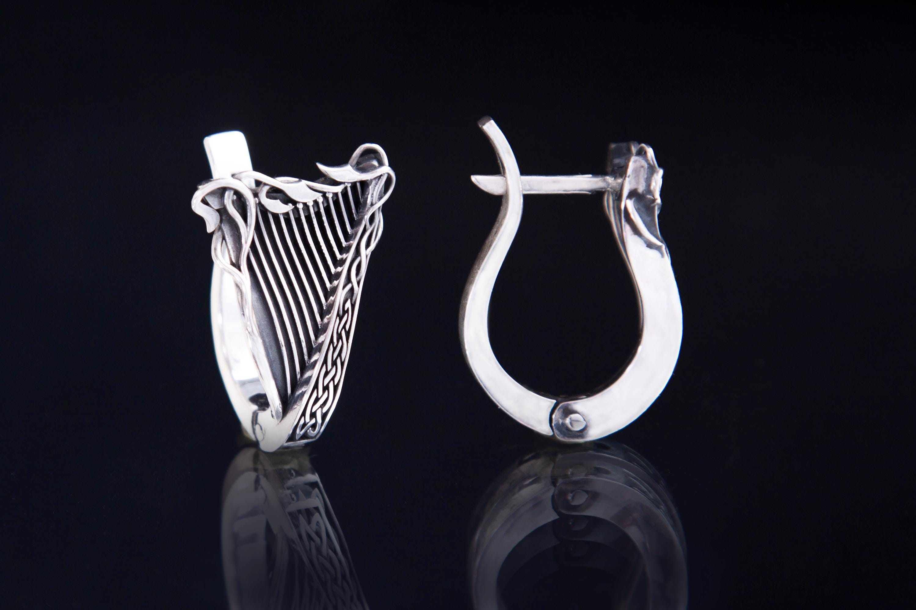 Celtic harp sterling silver earrings on dark background