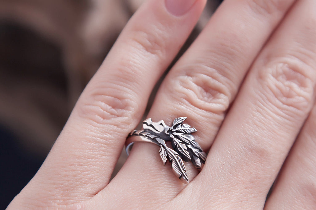 Close up of Quetzalcoatl inspired silver ring with raised texture