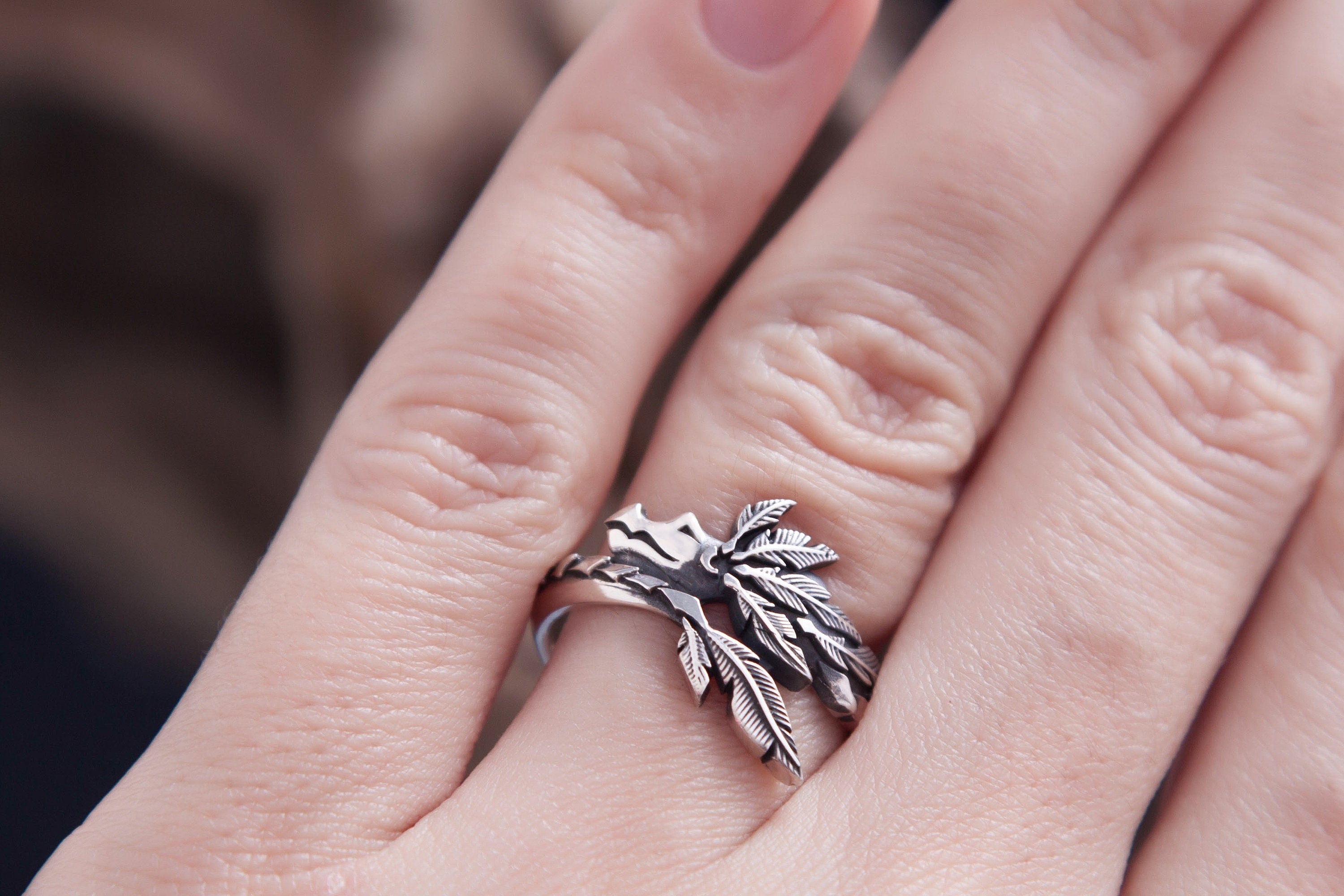 Close up of Quetzalcoatl inspired silver ring with raised texture