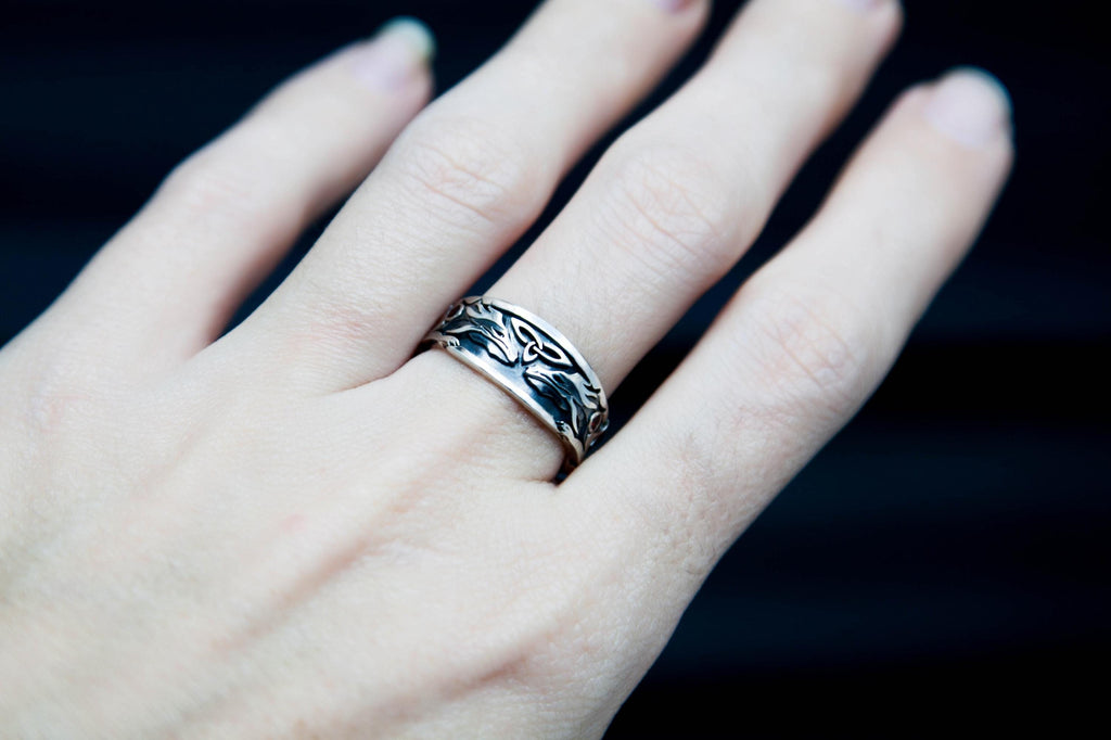 Garnet Celtic dragon ring shown on hand