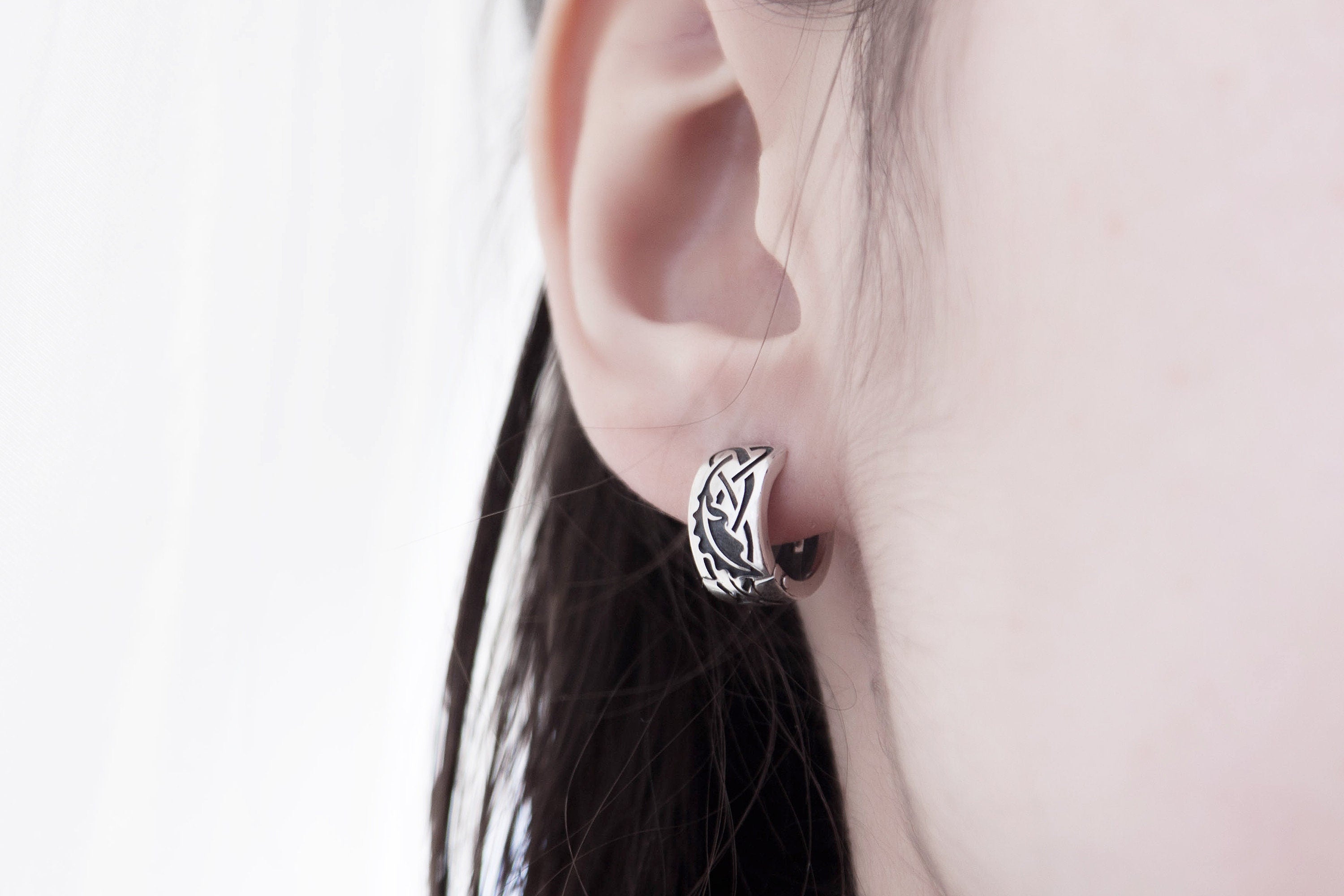 Sterling silver oak leaf earrings on model