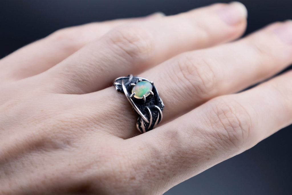 Ethiopian opal silver ring worn on hand