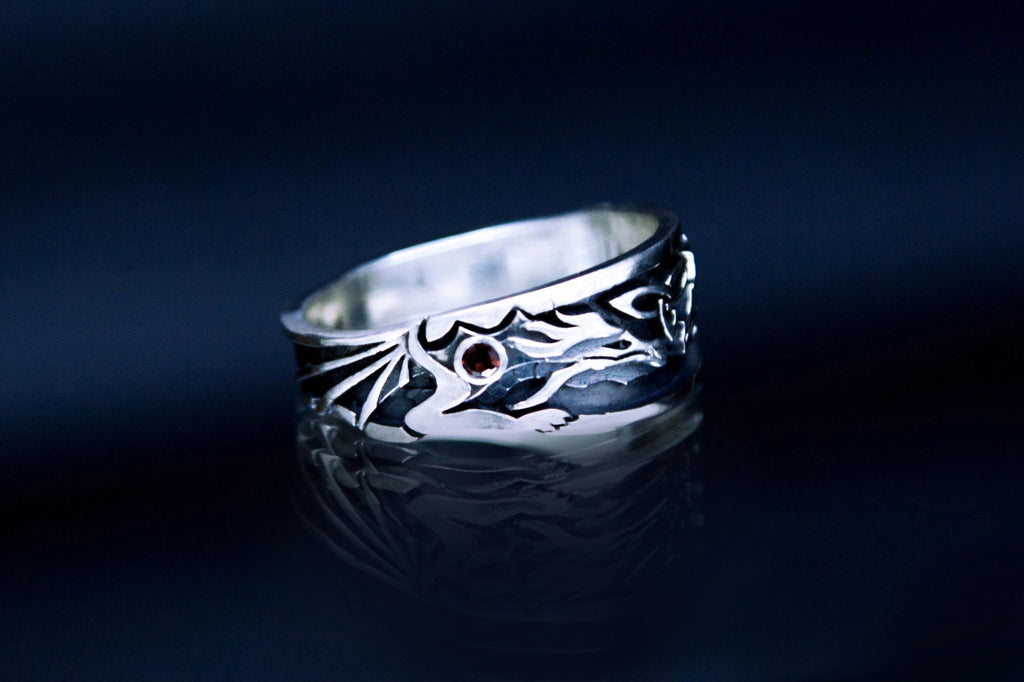 Handmade silver dragon motif ring with garnet accents