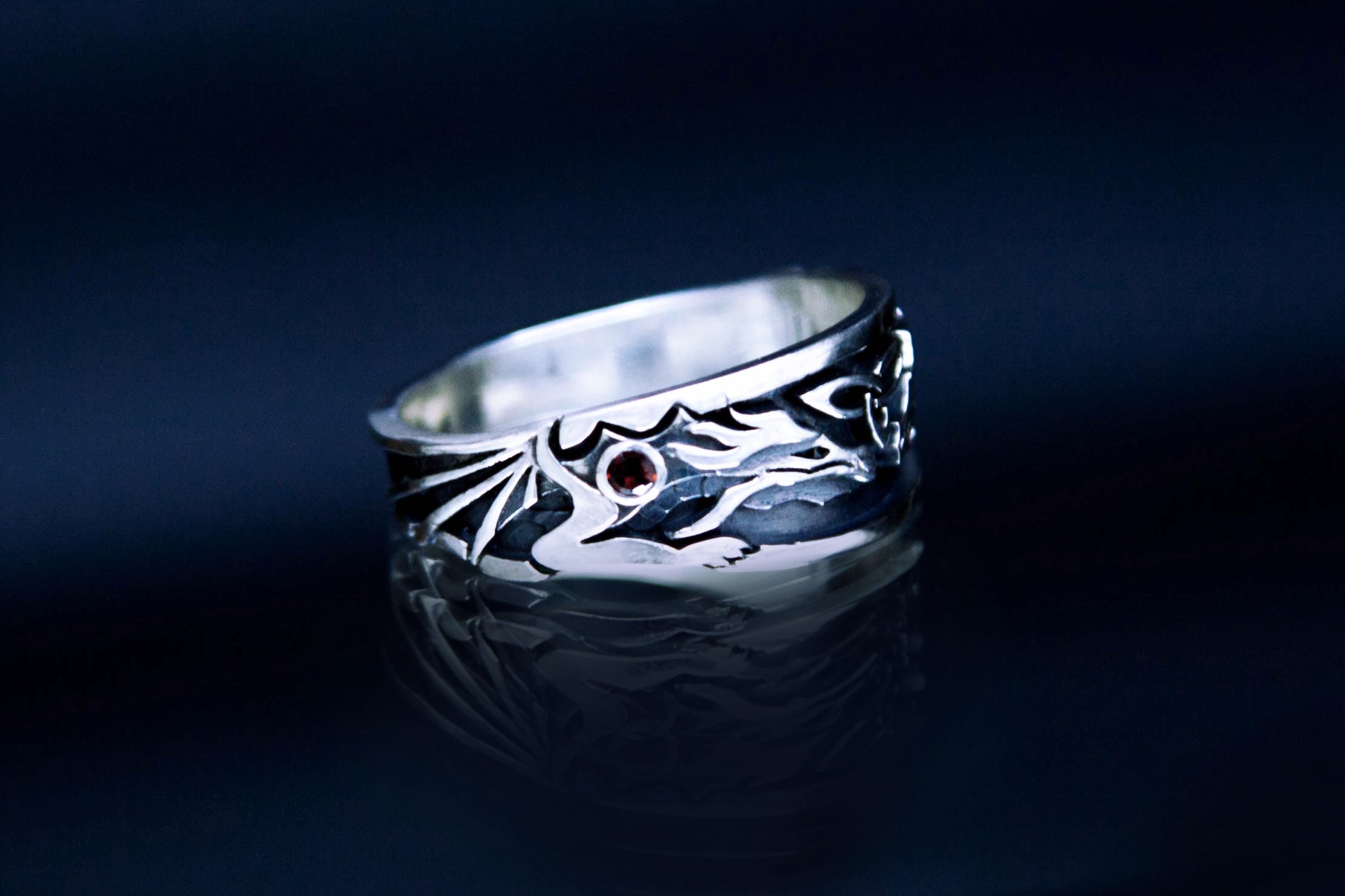 Handmade silver dragon motif ring with garnet accents