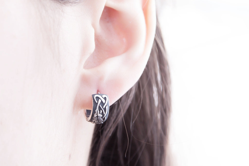 Sterling silver oak leaf earrings, worn on ear