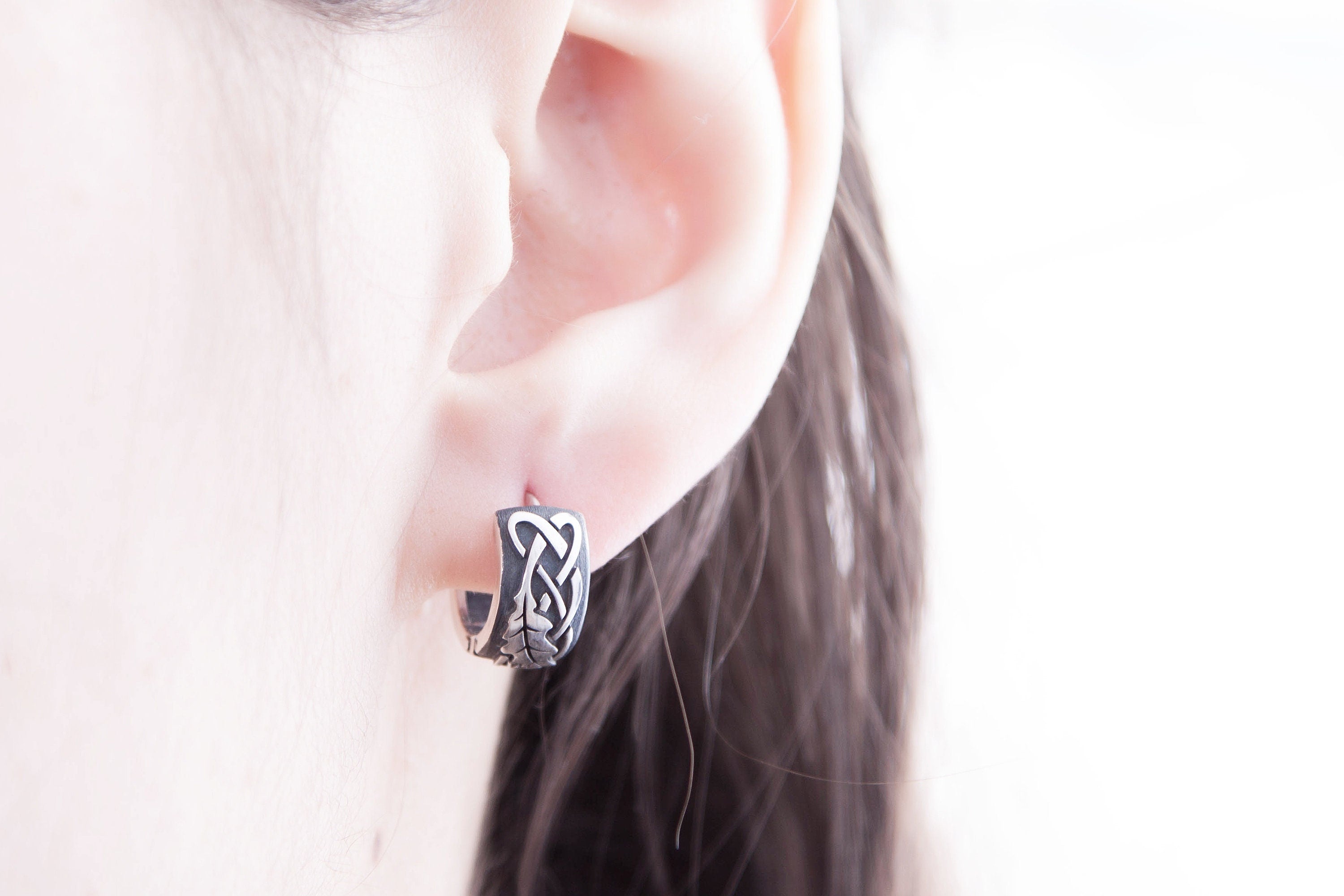 Sterling silver oak leaf earrings, worn on ear