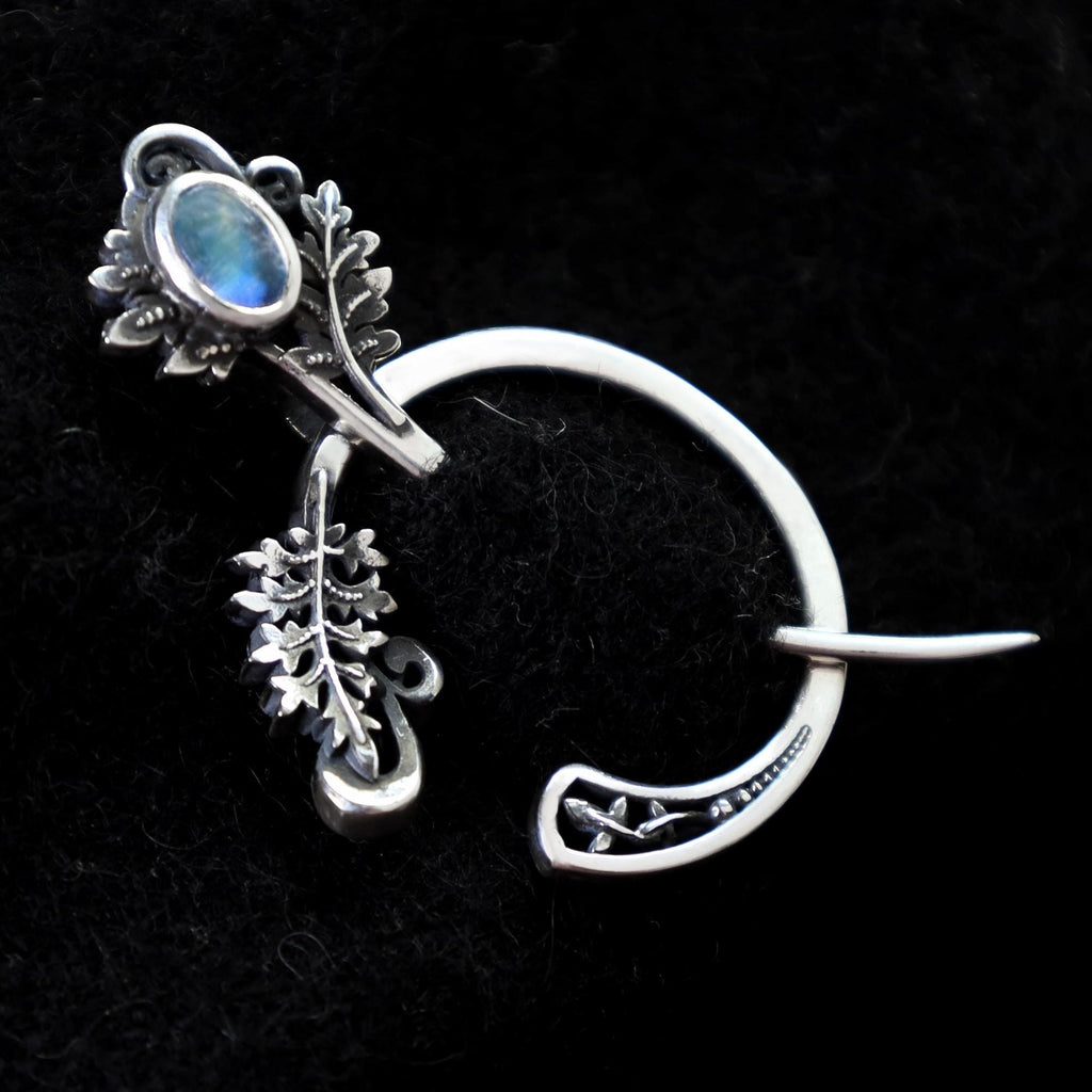 Silver fern fibula brooch with moonstone, front view