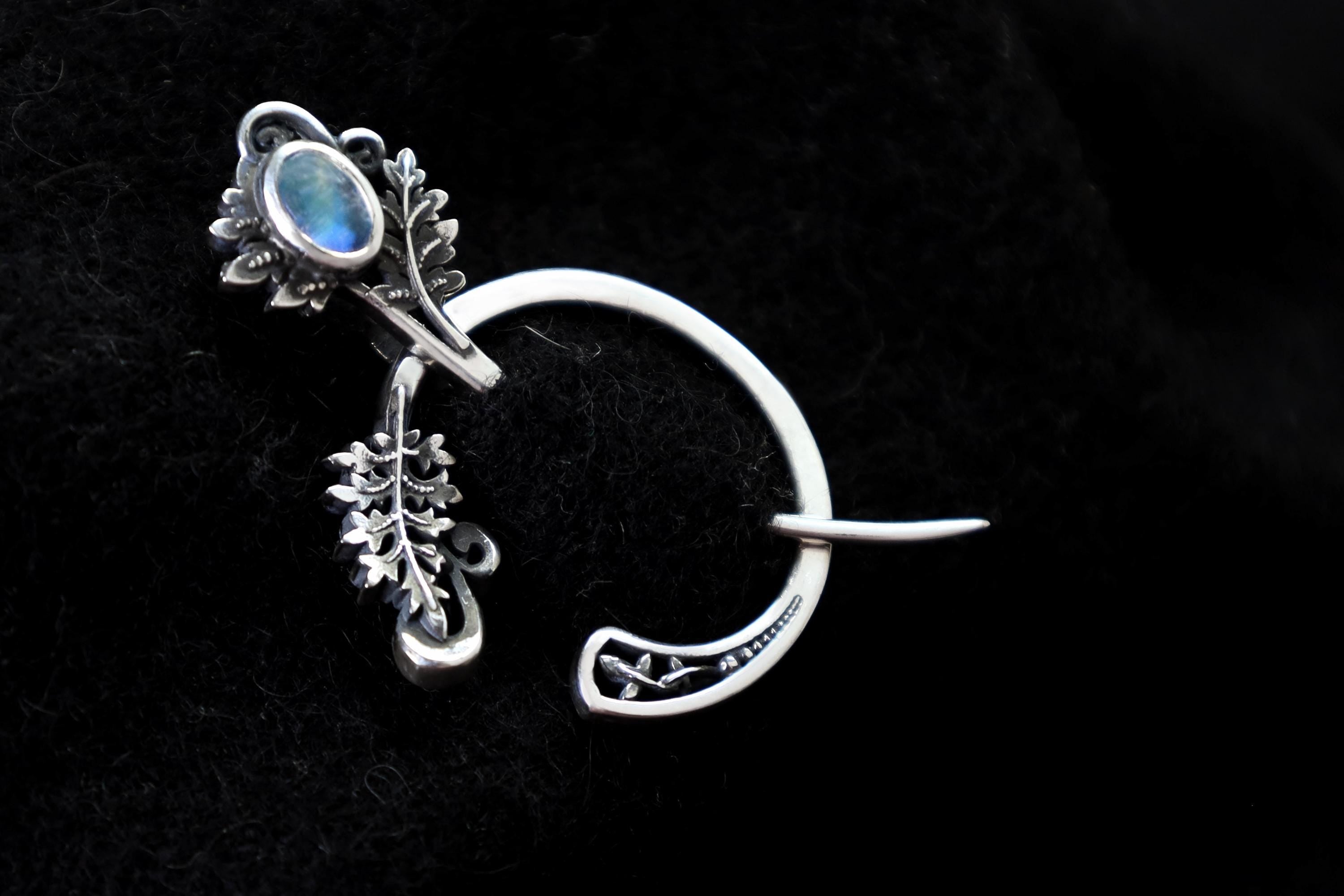 Silver fern fibula brooch with moonstone, front view
