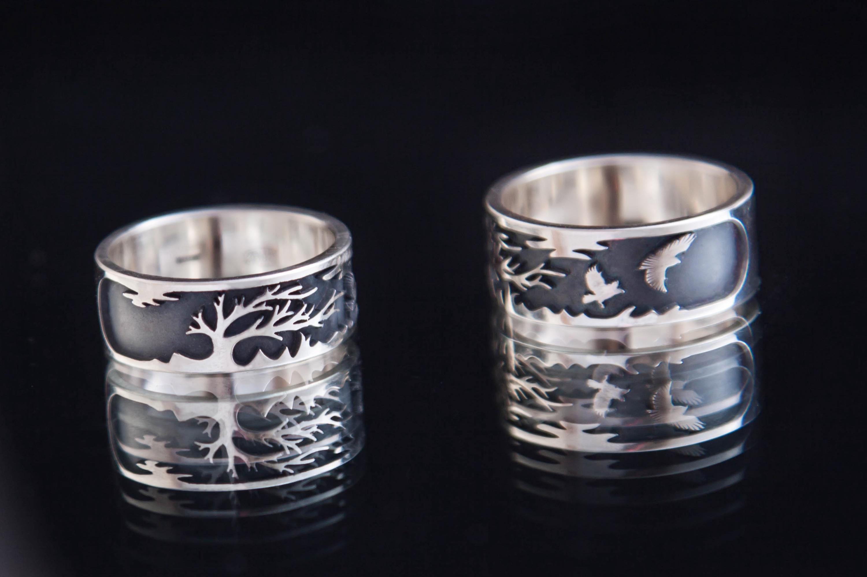 Sterling silver steppe ring with tree and two ravens on dark background