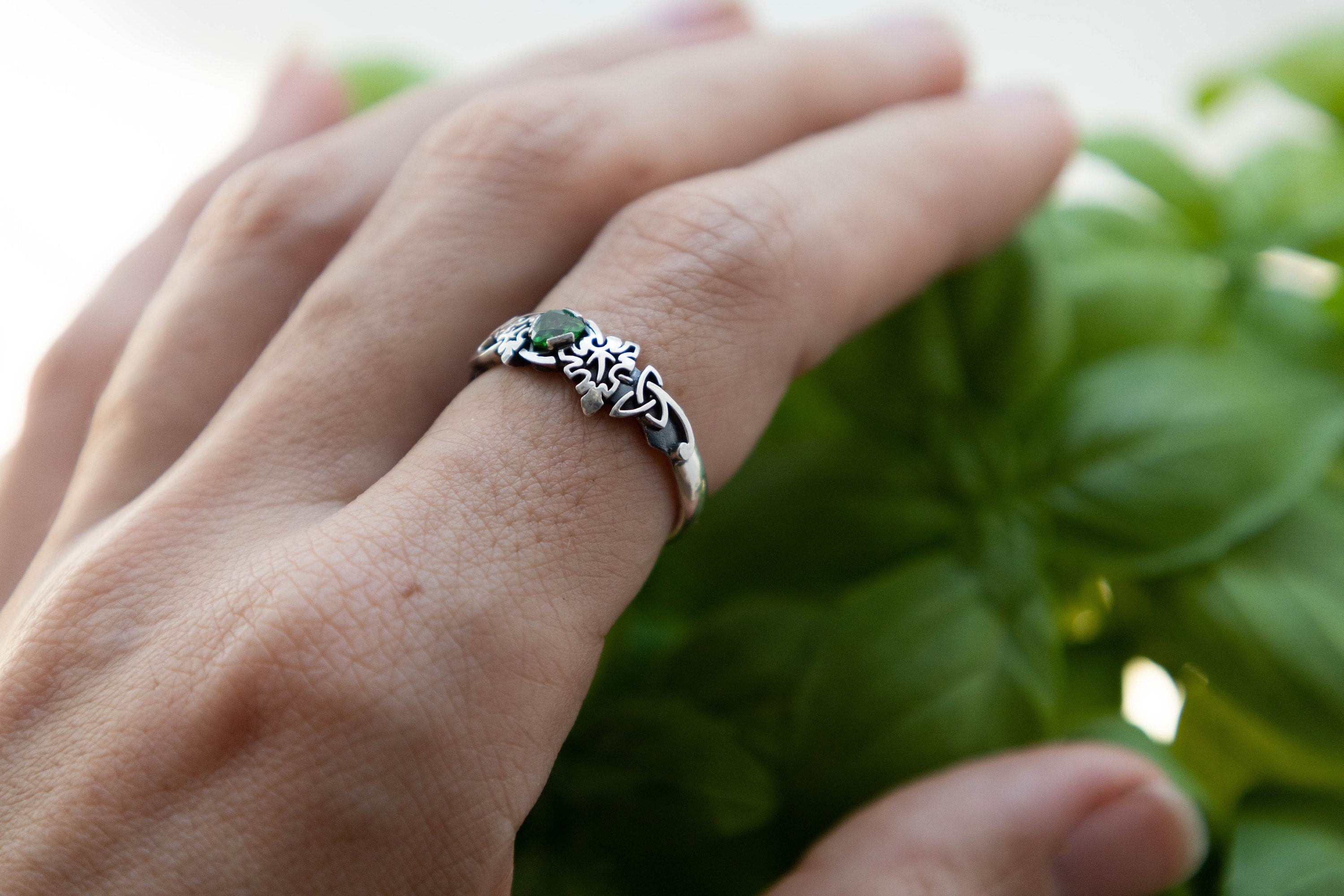 Green gemstone fantasy ring shown on hand