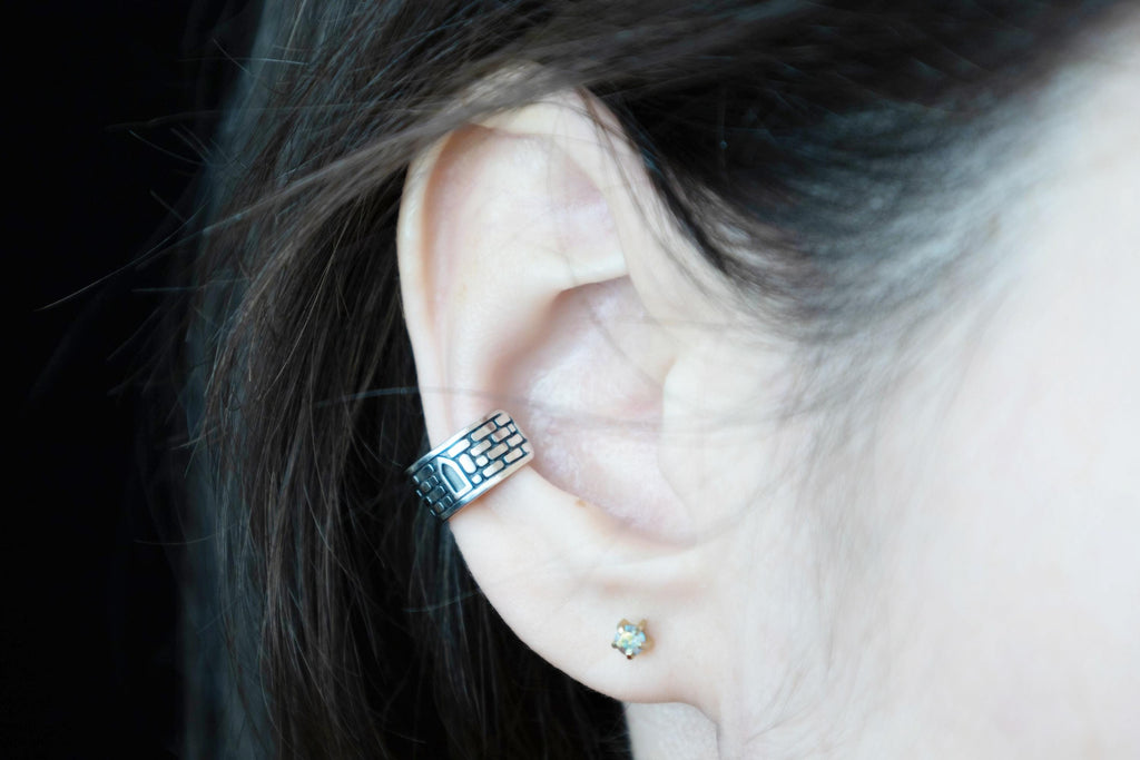 No piercing silver ear cuff worn on ear