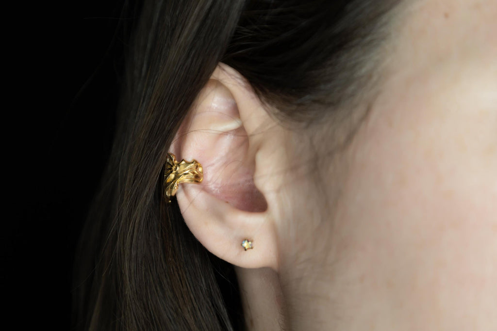 Sculptural dragon ear cuff worn on ear