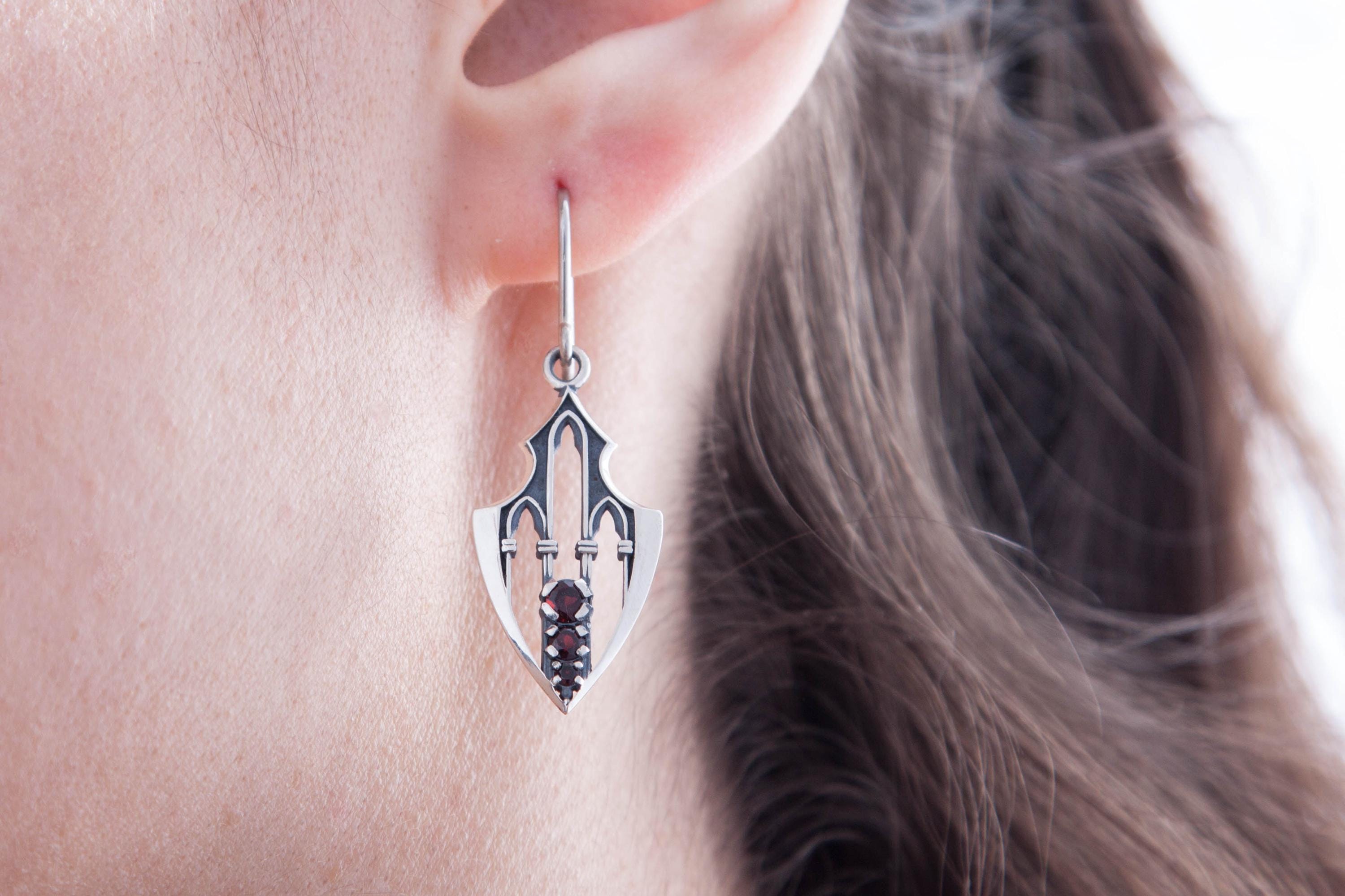 Gothic fantasy silver earrings modeled on ear, elongated shield form