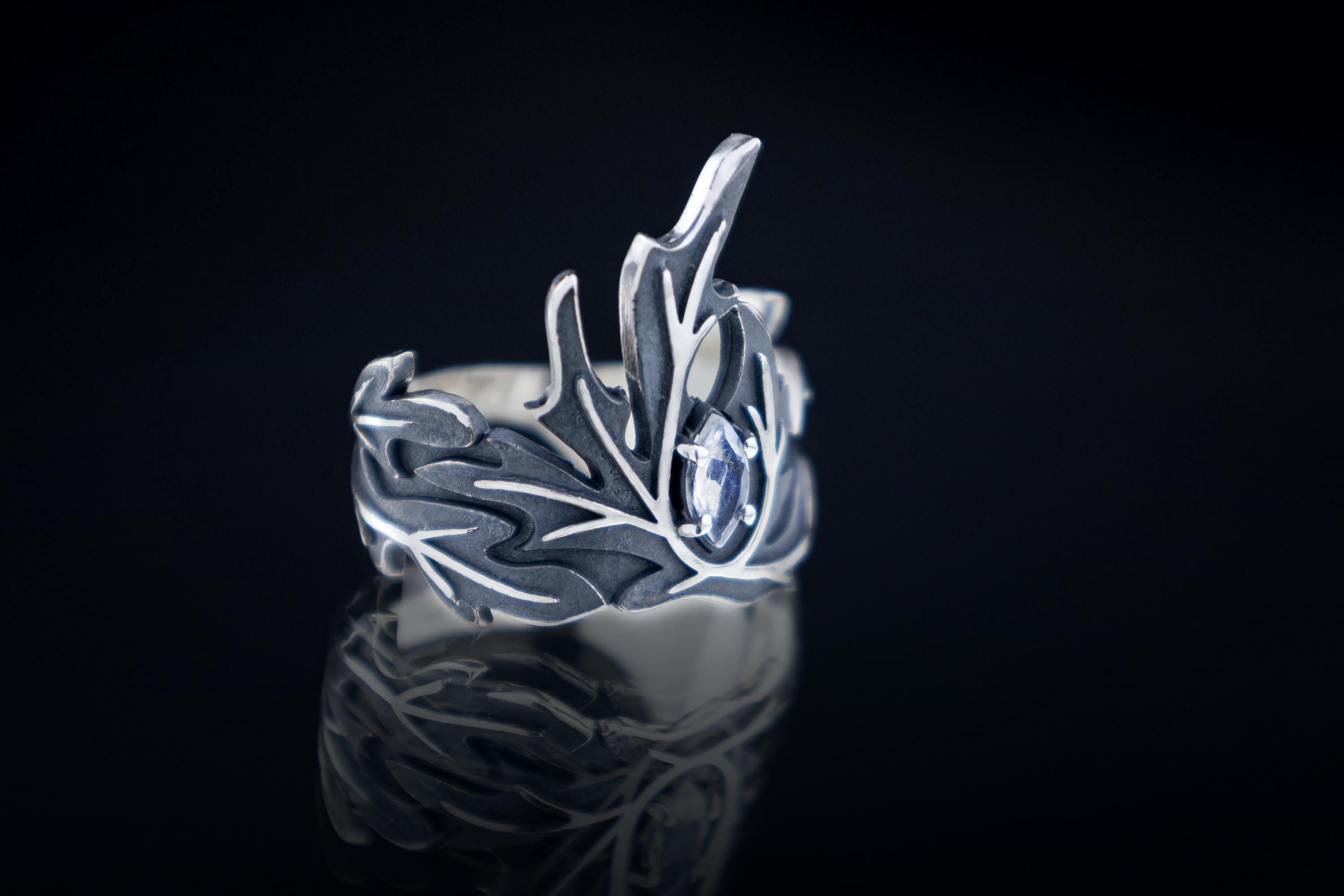 Silver wormwood crown ring with marquise moonstone on dark background