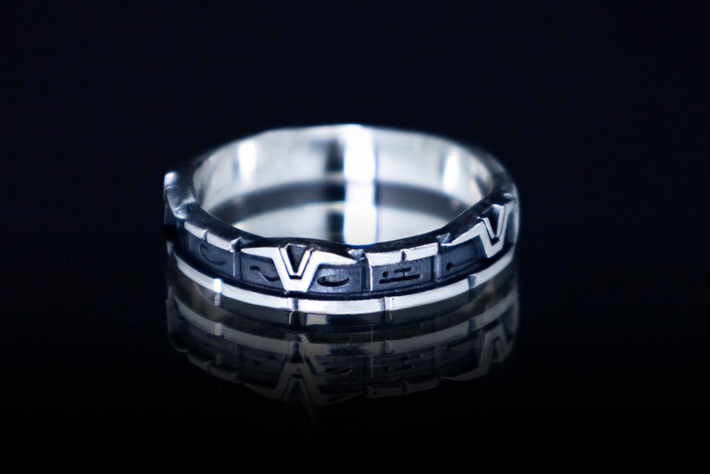Sterling silver Star gate glyph ring on dark background