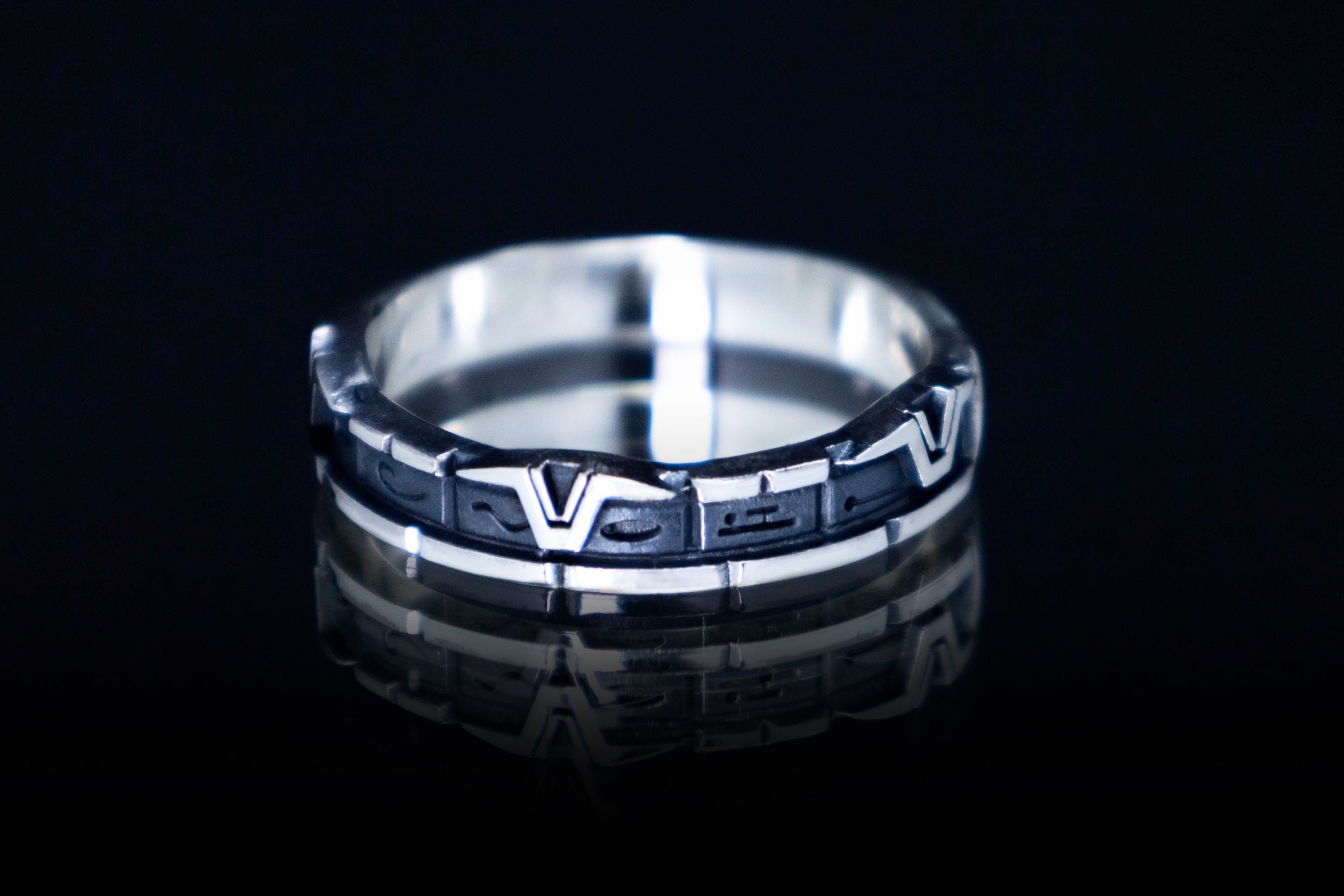 Sterling silver Star gate glyph ring on dark background