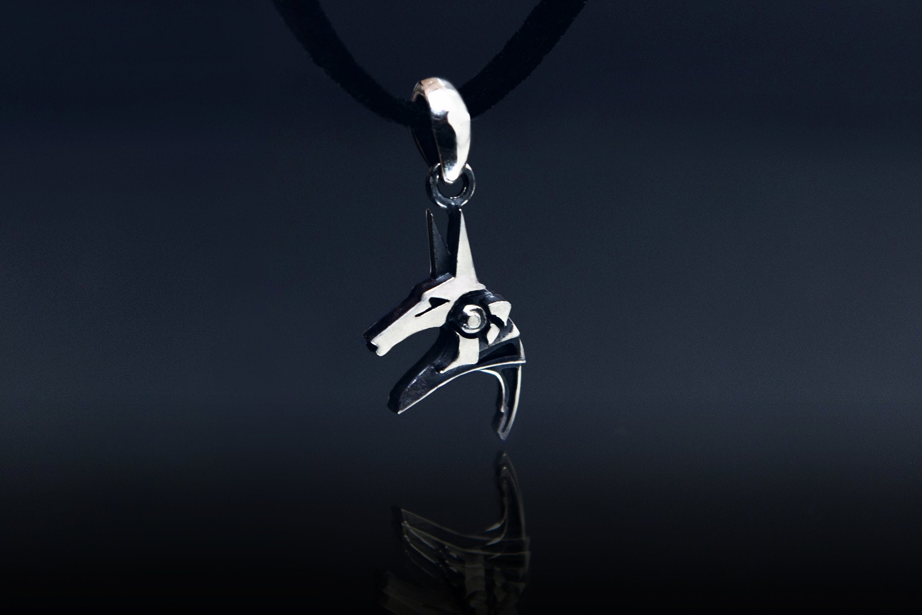 Sterling silver Anubis charm close-up, oxidized details
