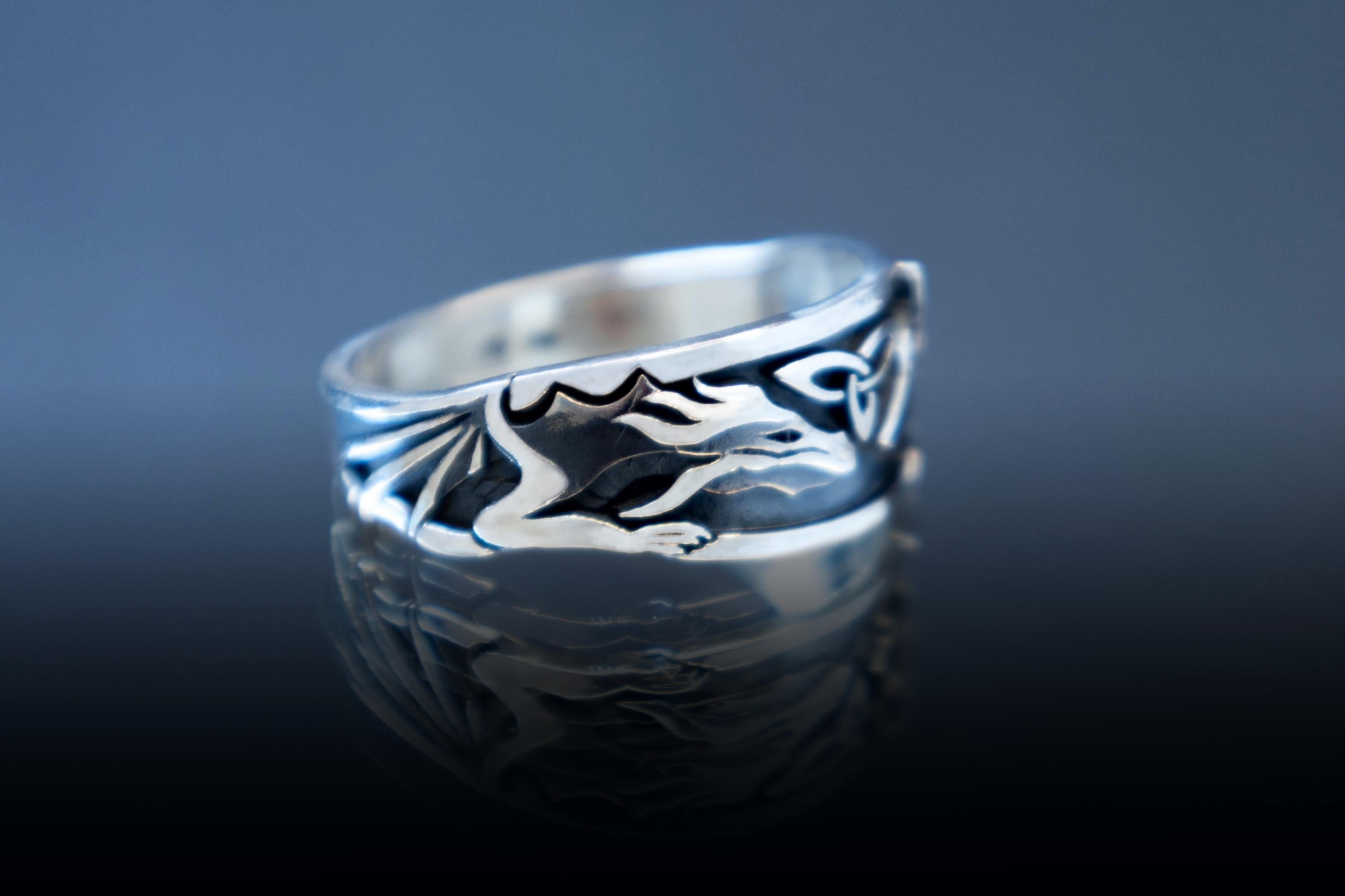 Silver ring with dragon and fox intertwined design