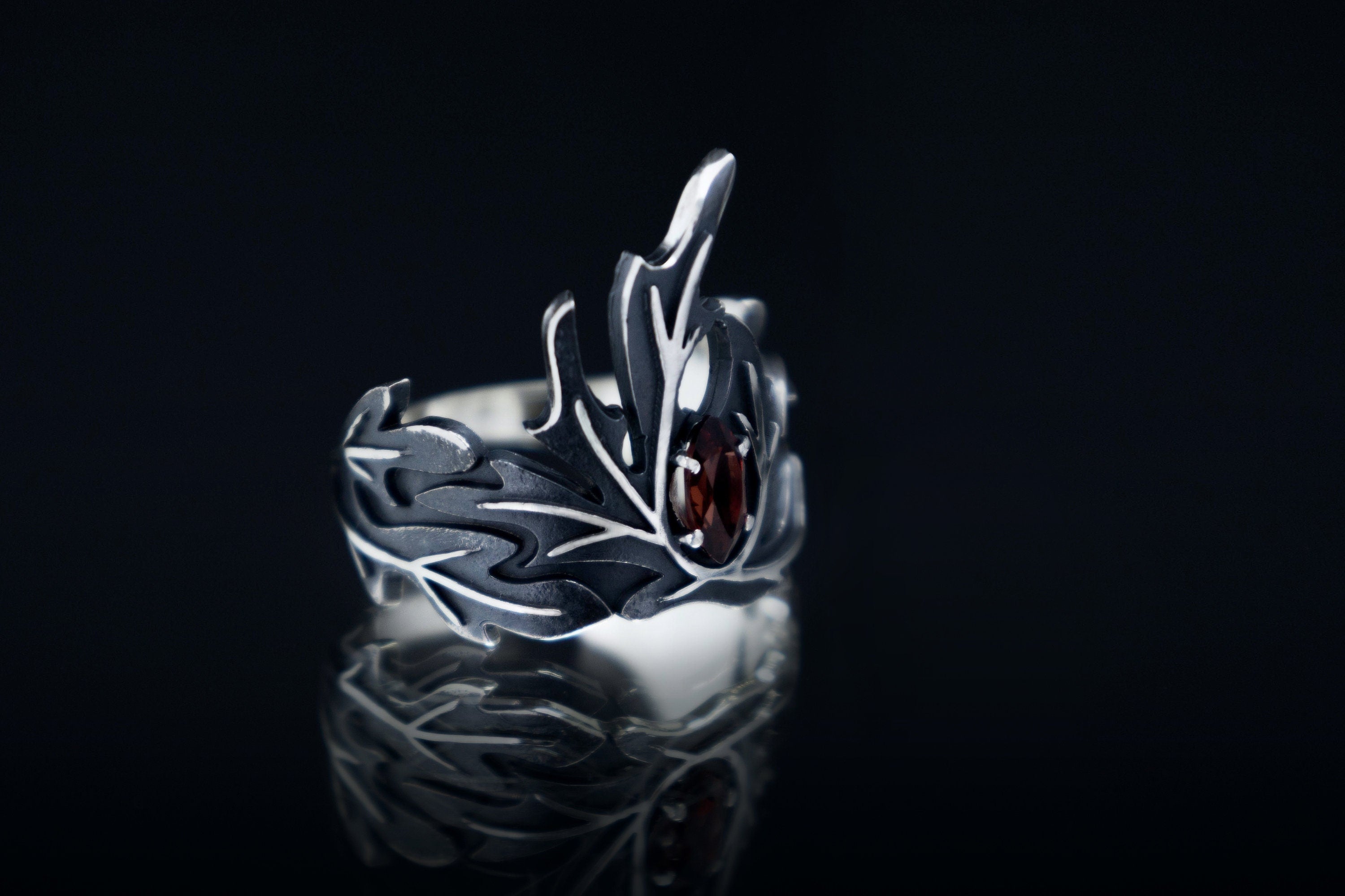 Sterling silver wormwood leaf ring with garnet, magic statement band