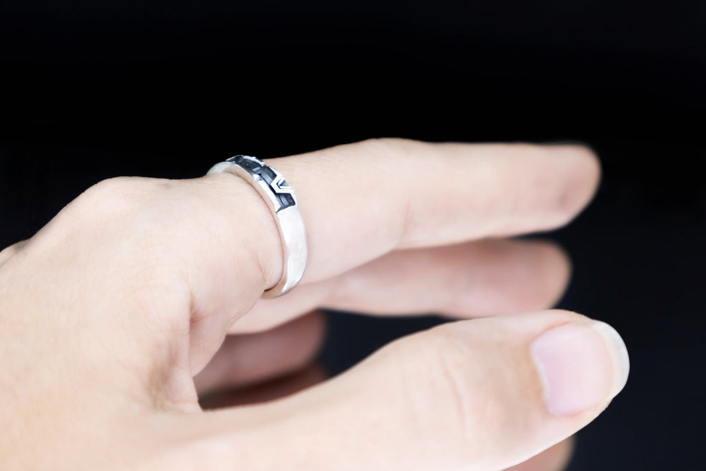 Unisex silver portal glyph band worn on hand