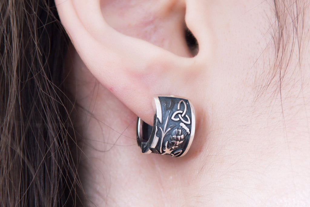 Celtic thistle earring worn on ear