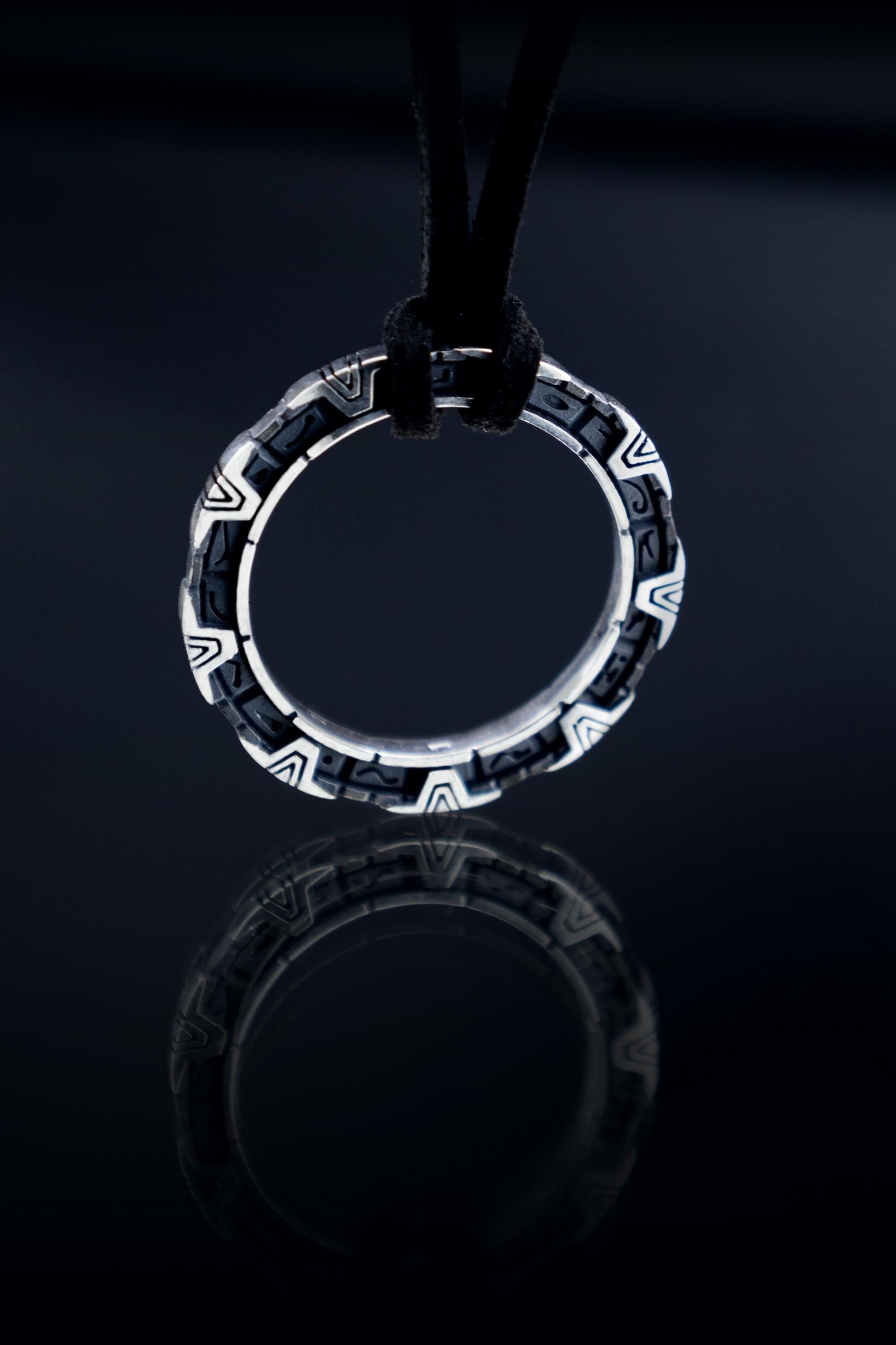 Round silver StarGate pendant inspired by 1994 movie