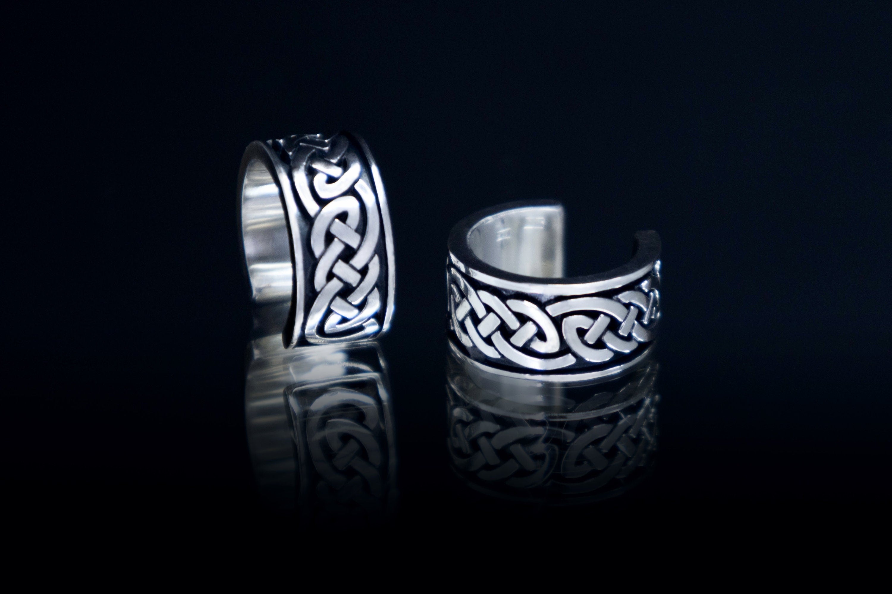 Mini Celtic silver ear cuffs on dark background