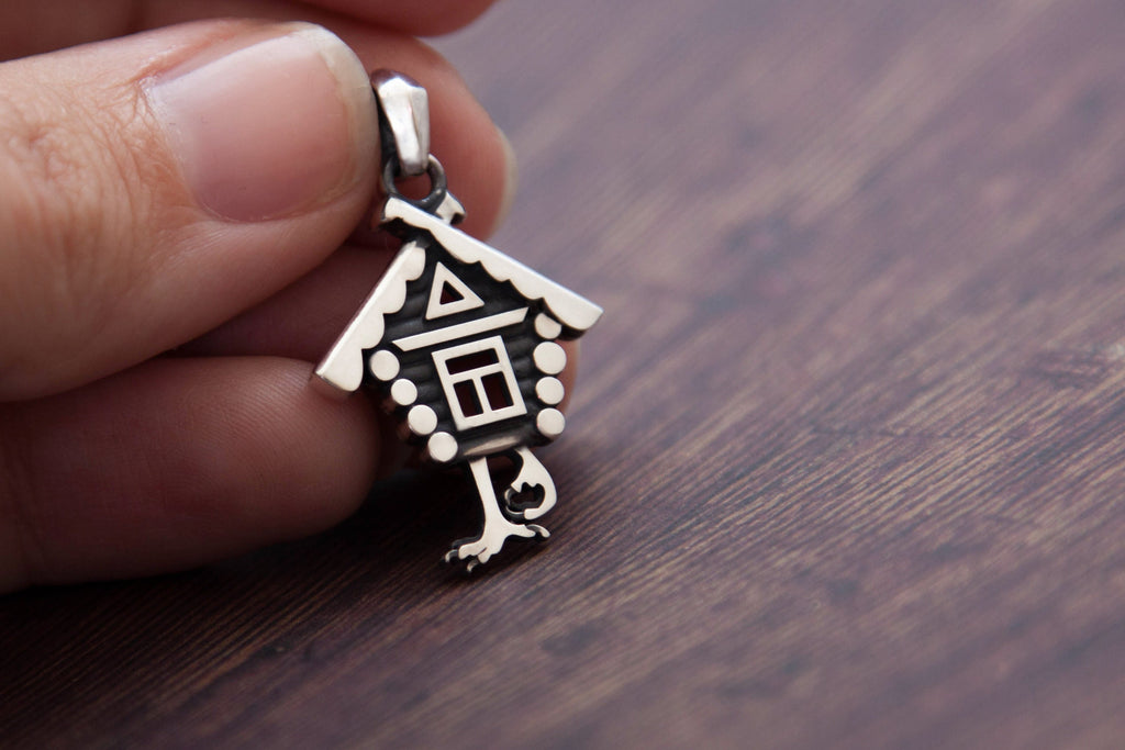 Baba Yaga house necklace styled on wood background