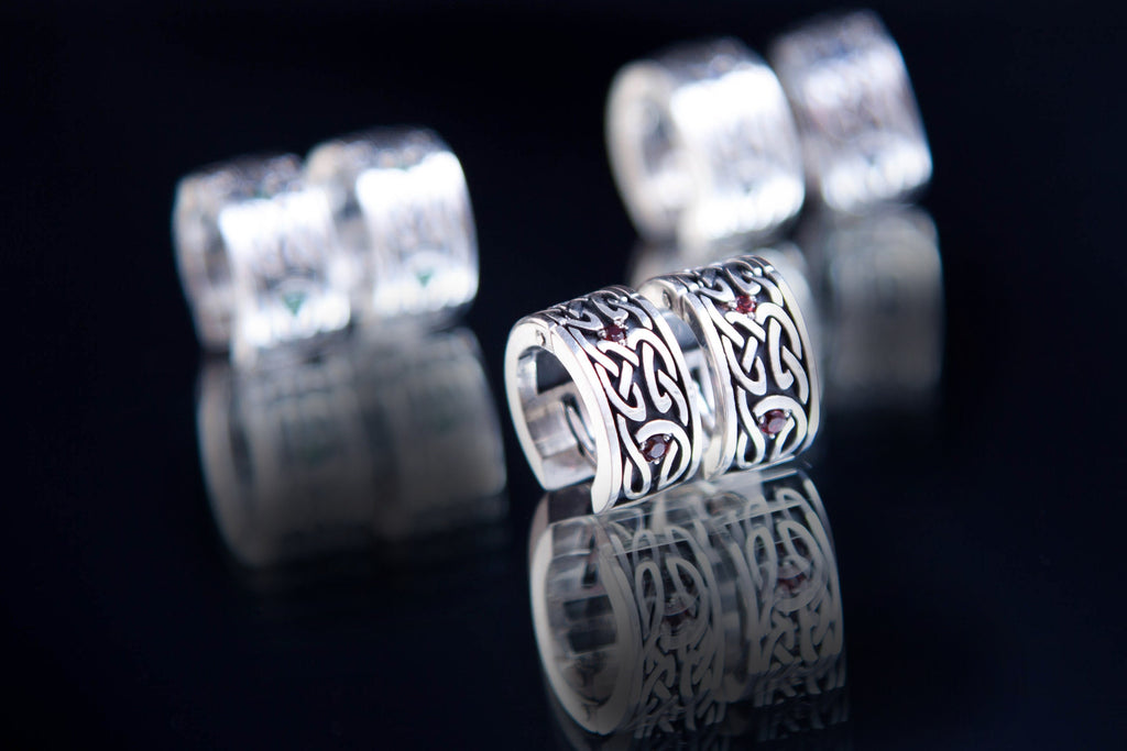 Pair of Celtic knot huggie earrings with garnets