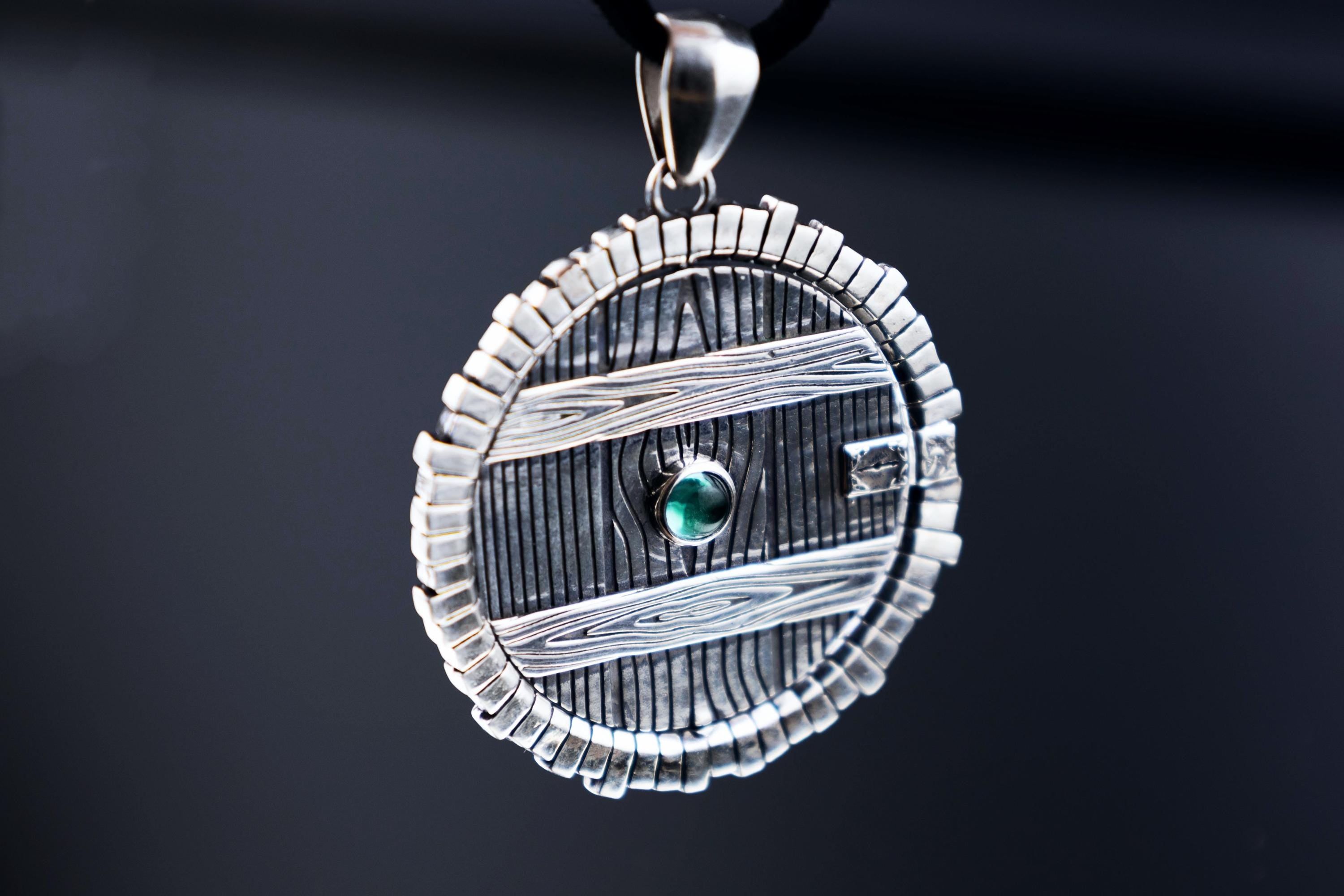 Silver spinning door pendant with Paraiba crystal