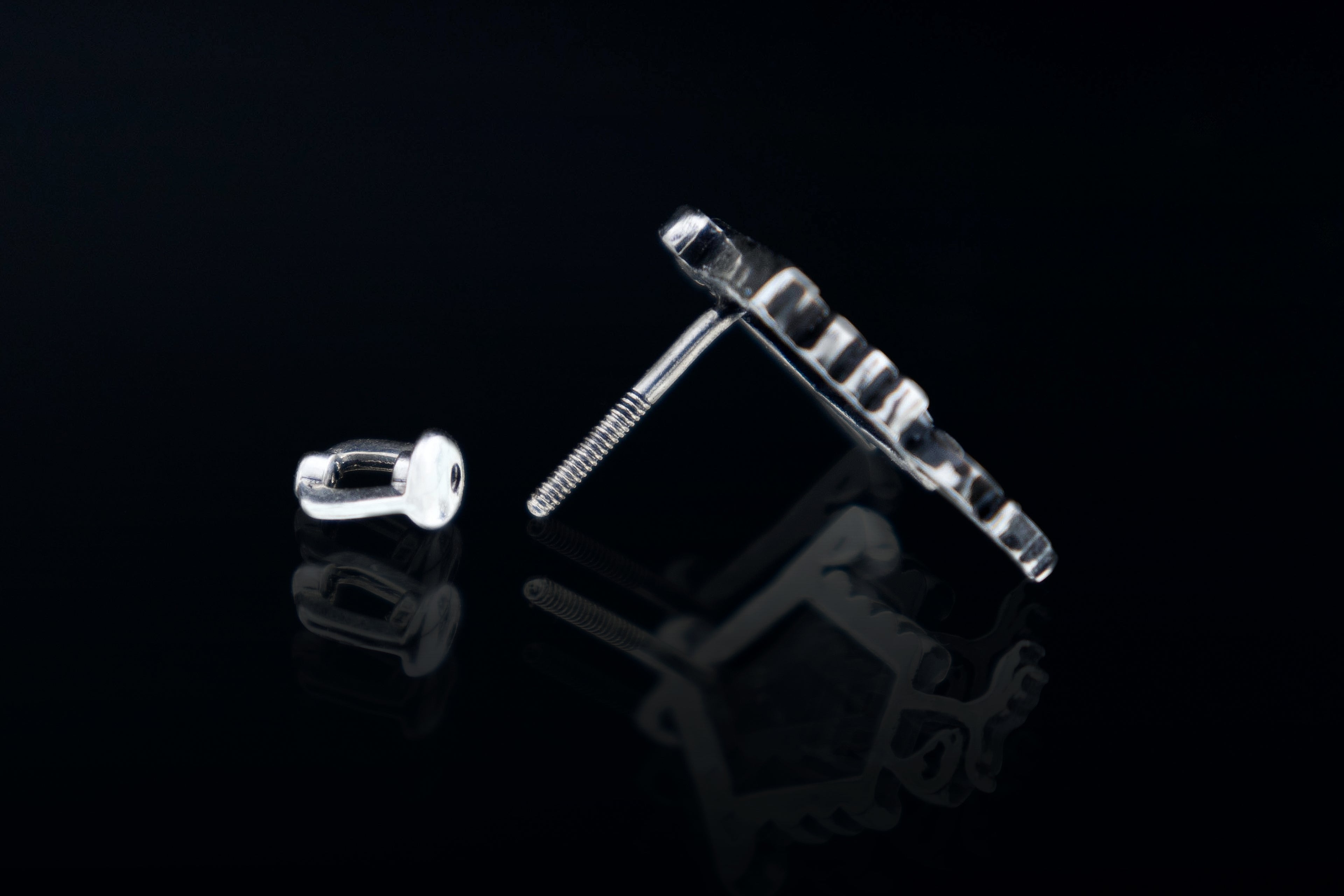 Silver screw back stud earrings detail