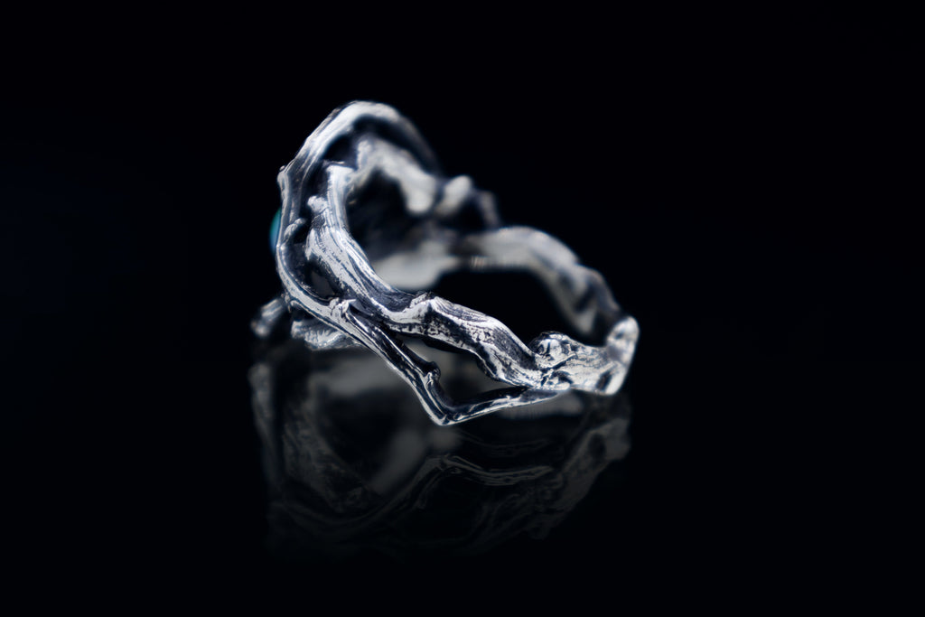 Back view of handmade sterling silver twig ring, oxidized and polished texture, back side