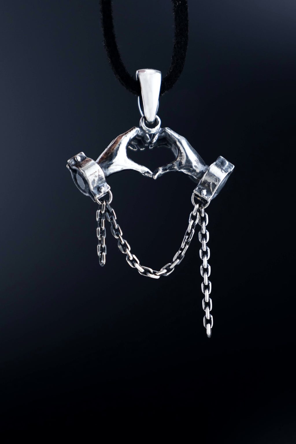 Back of solid silver pendant, Heart of Hands, protest art