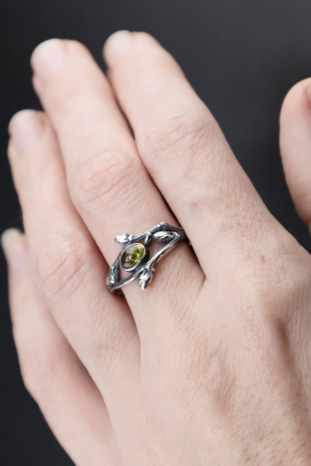 Peridot nature ring worn on hand