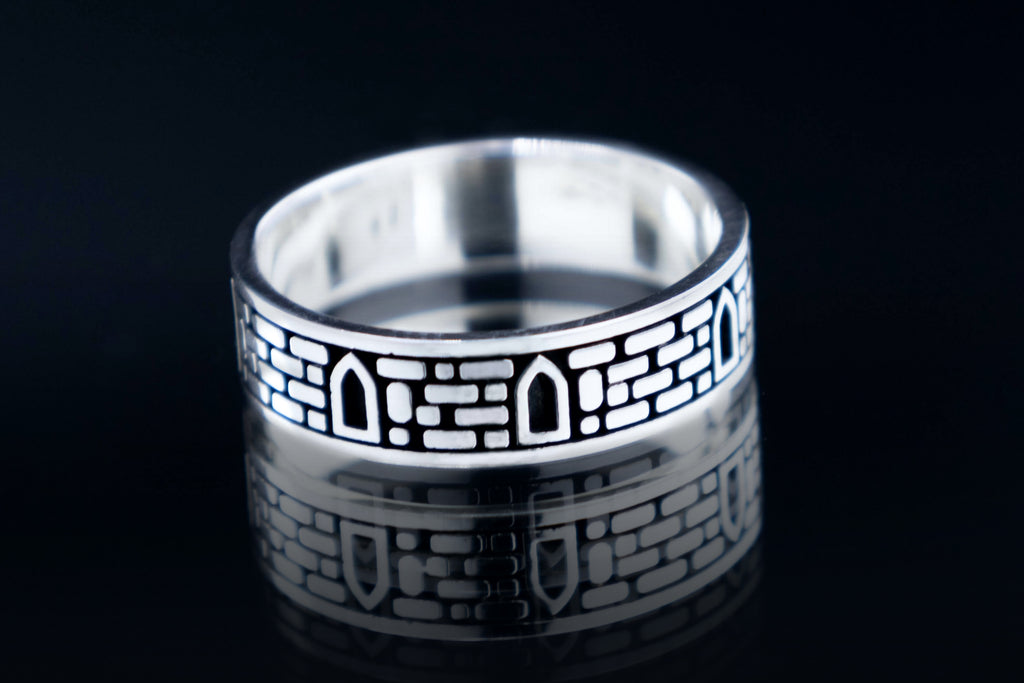 Sterling silver ring with medieval castle stone wall texture and windows, gothic architectural jewelry artifact.