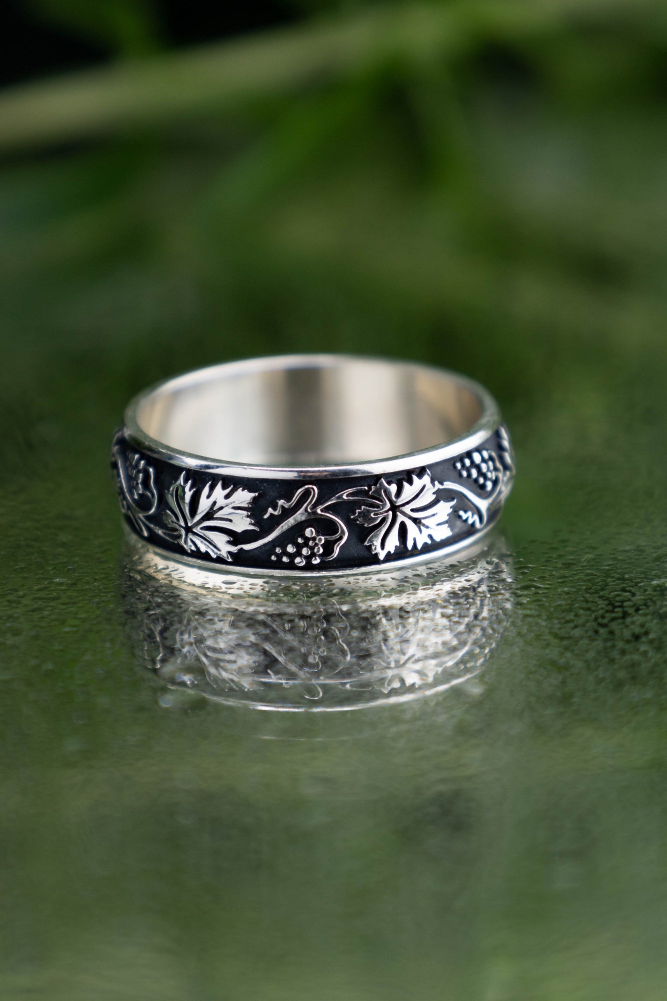 Detailed vineyard leaf ring in oxidized 925 silver, continuous vine and berry solid casting, dark academia style botanical band for women.