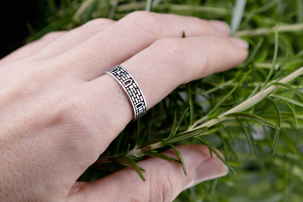 Handmade masonry band on finger showing 5-7mm width scale, nature inspired elven architecture ring silver.