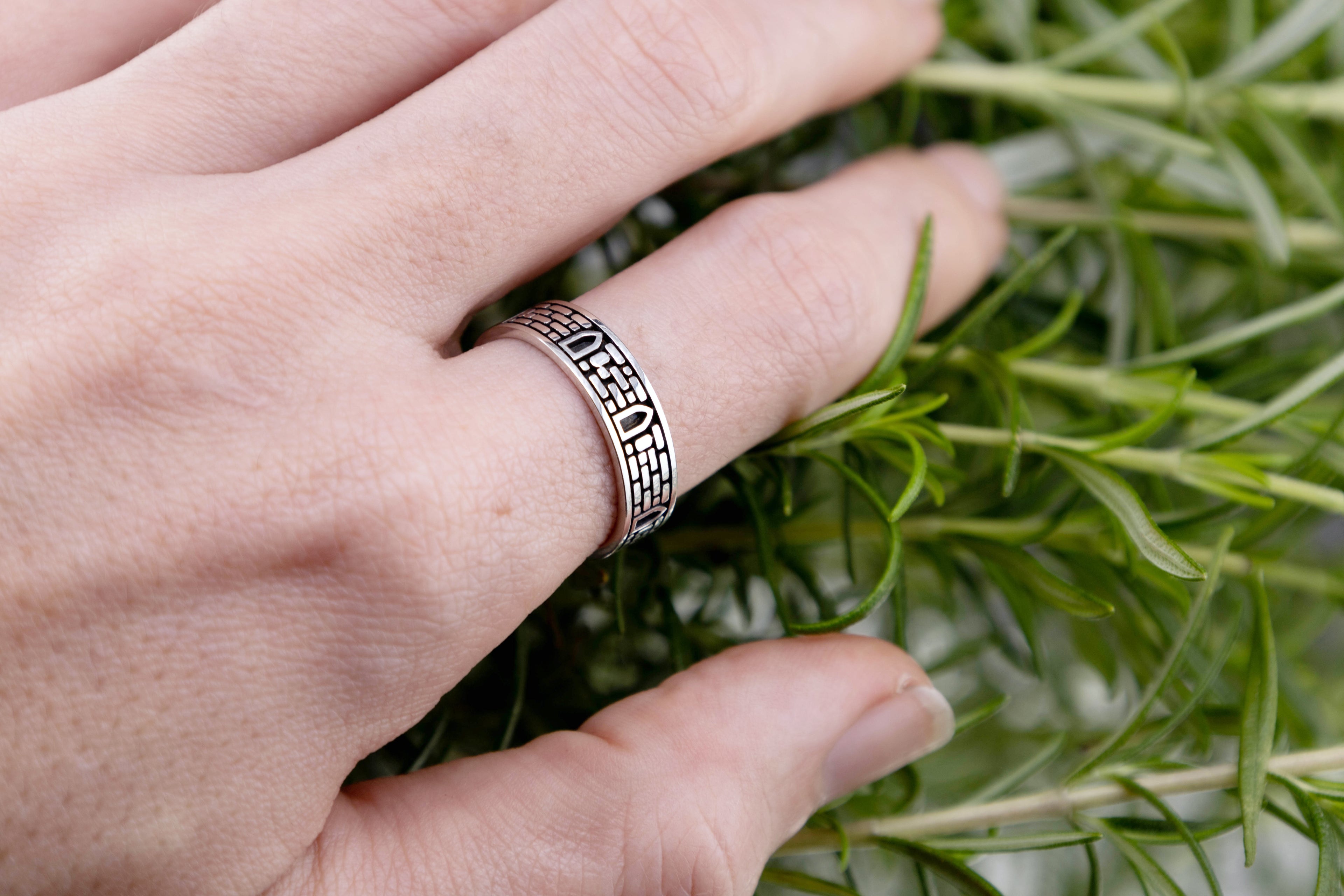 Handmade masonry band on finger showing 5-7mm width scale, nature inspired elven architecture ring silver.