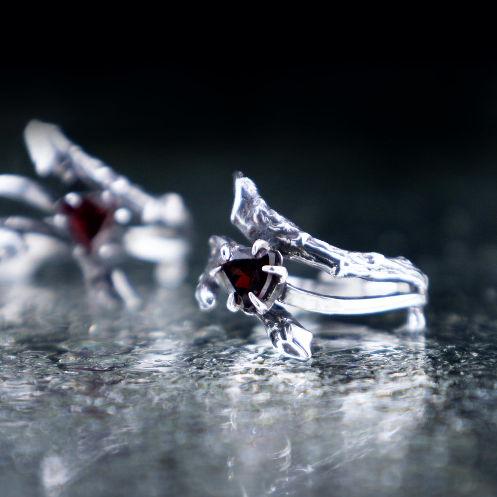 Silver tree branch ring featuring a triangular red garnet crystal, unique elven style gothic engagement ring.